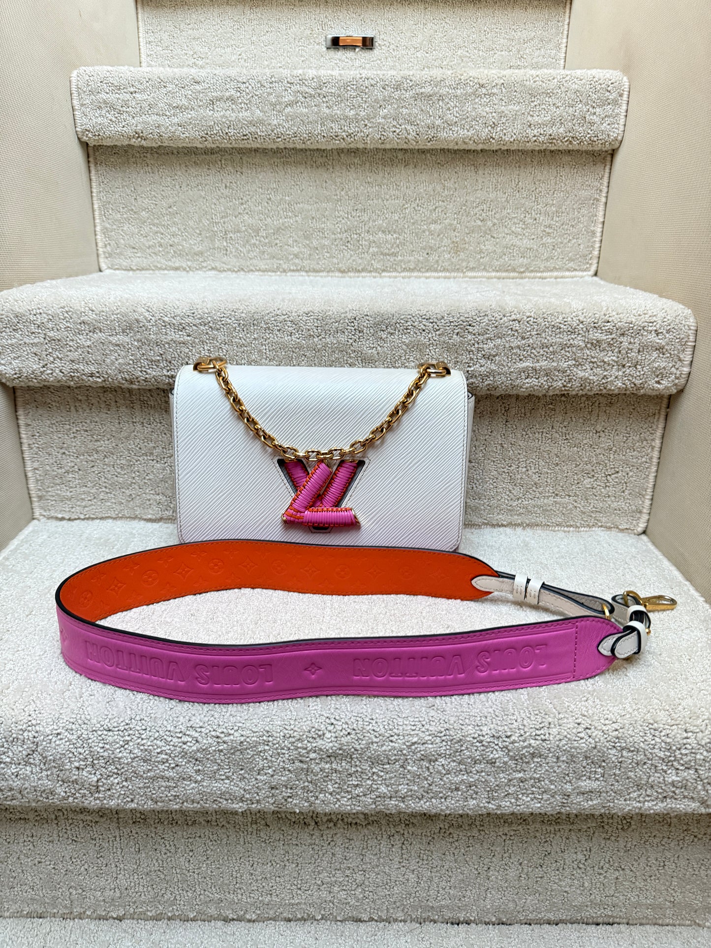 Authenticated Louis Vuitton Twist MM handbag White Epi Leather with Pink and orange accents in excellent condition luxury designer shoulder bag on resale from Purseonal shopper 