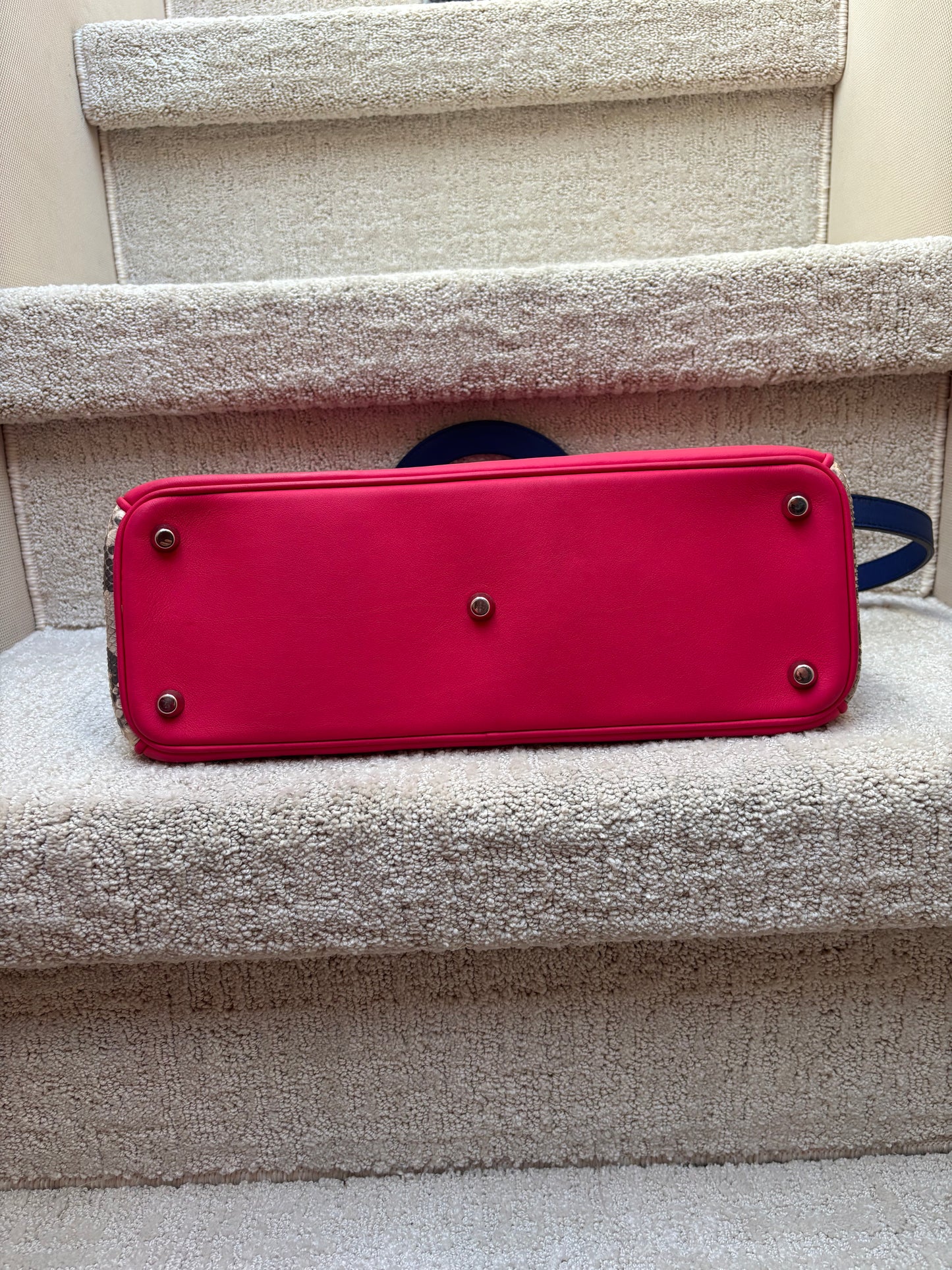 bottom of dior tote showing clean condition with silver feet.