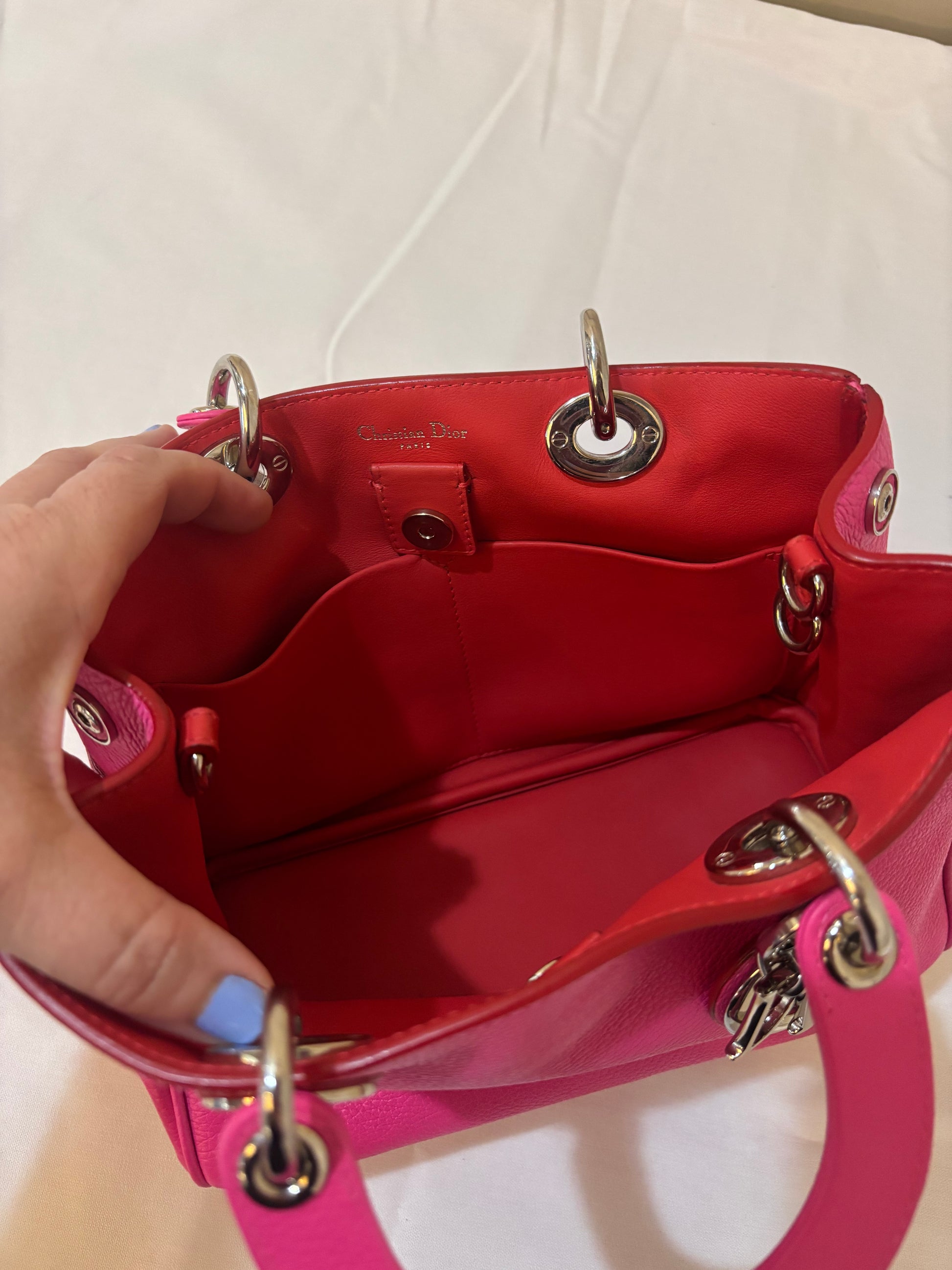 Interior view of Dior diorissima tote small in hot pink with red leather interior