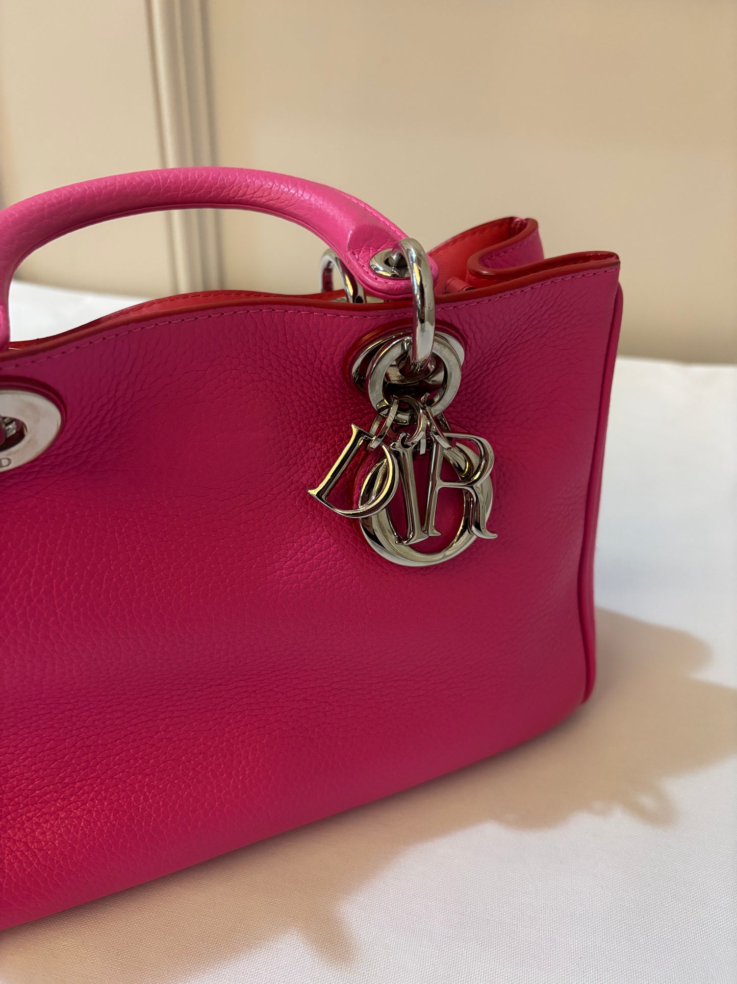 close up of silver dior charms on tote for sale 