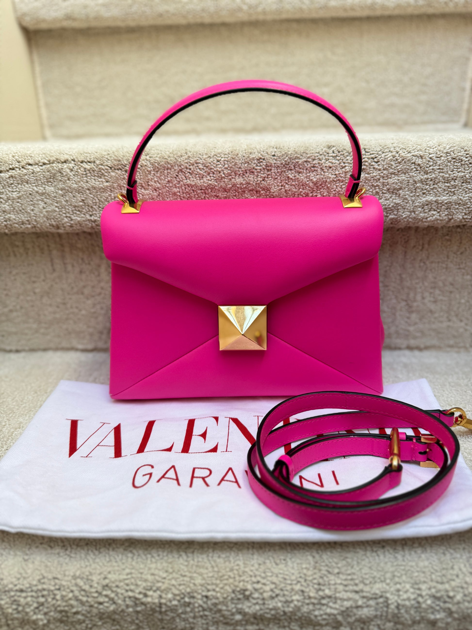 Valentino bright pink one stud top handle and crossbody handbag is authentic and preowned and offered for sale from purseonalshopper