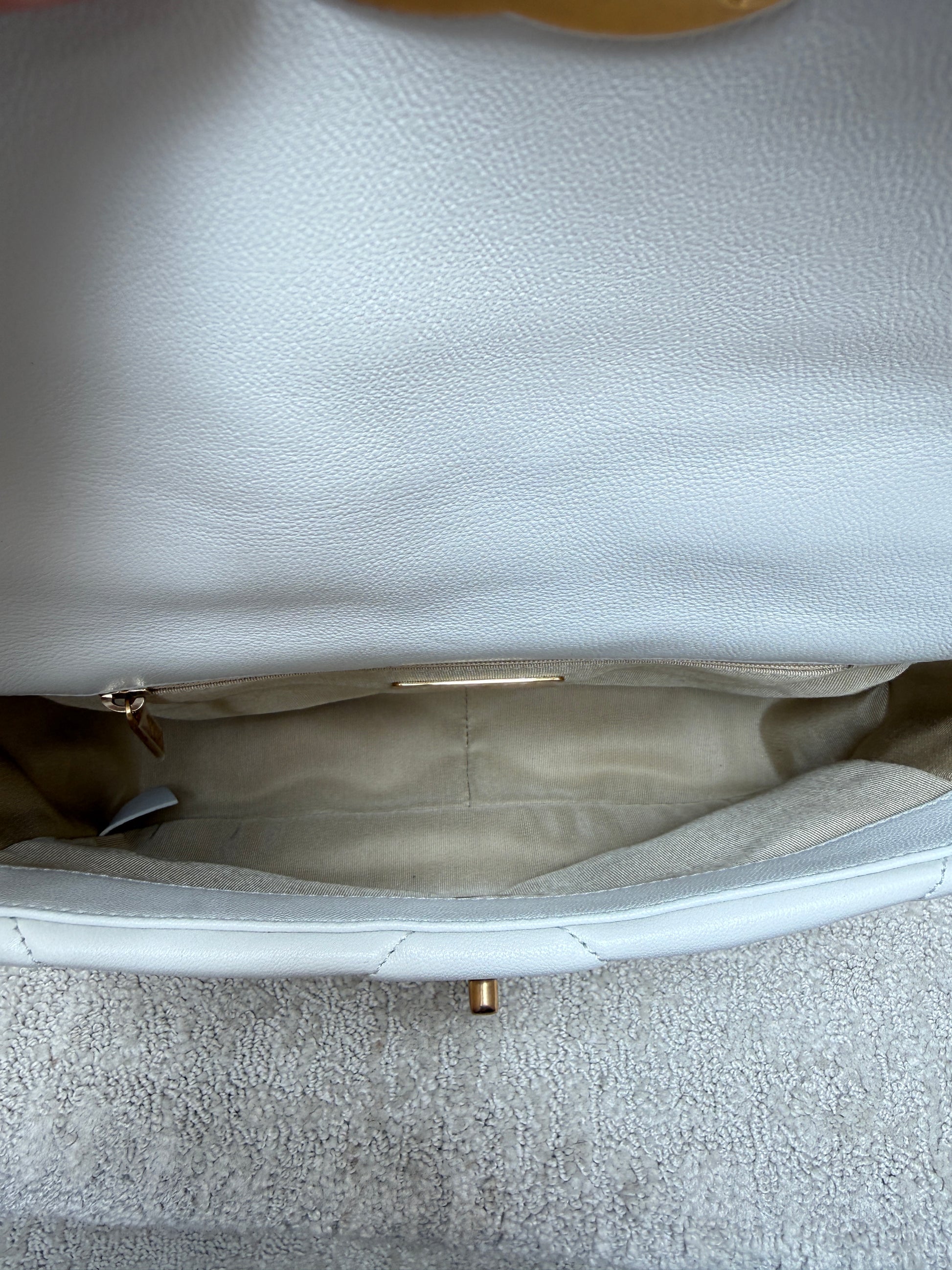 view of interior of chanel 19 in white leather with beige fabric 