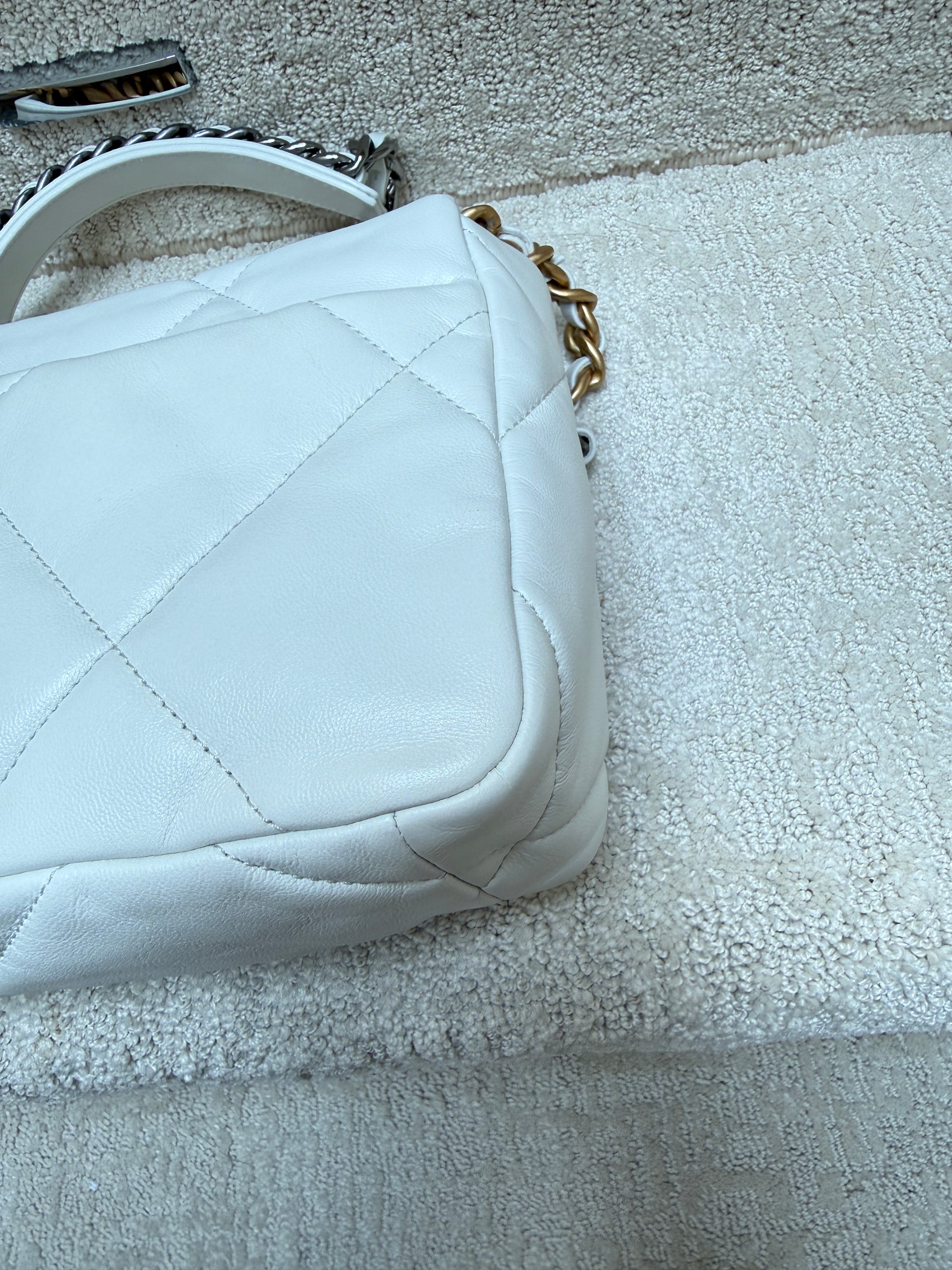 closed of rear back right corner on chanel 19 handbag in white