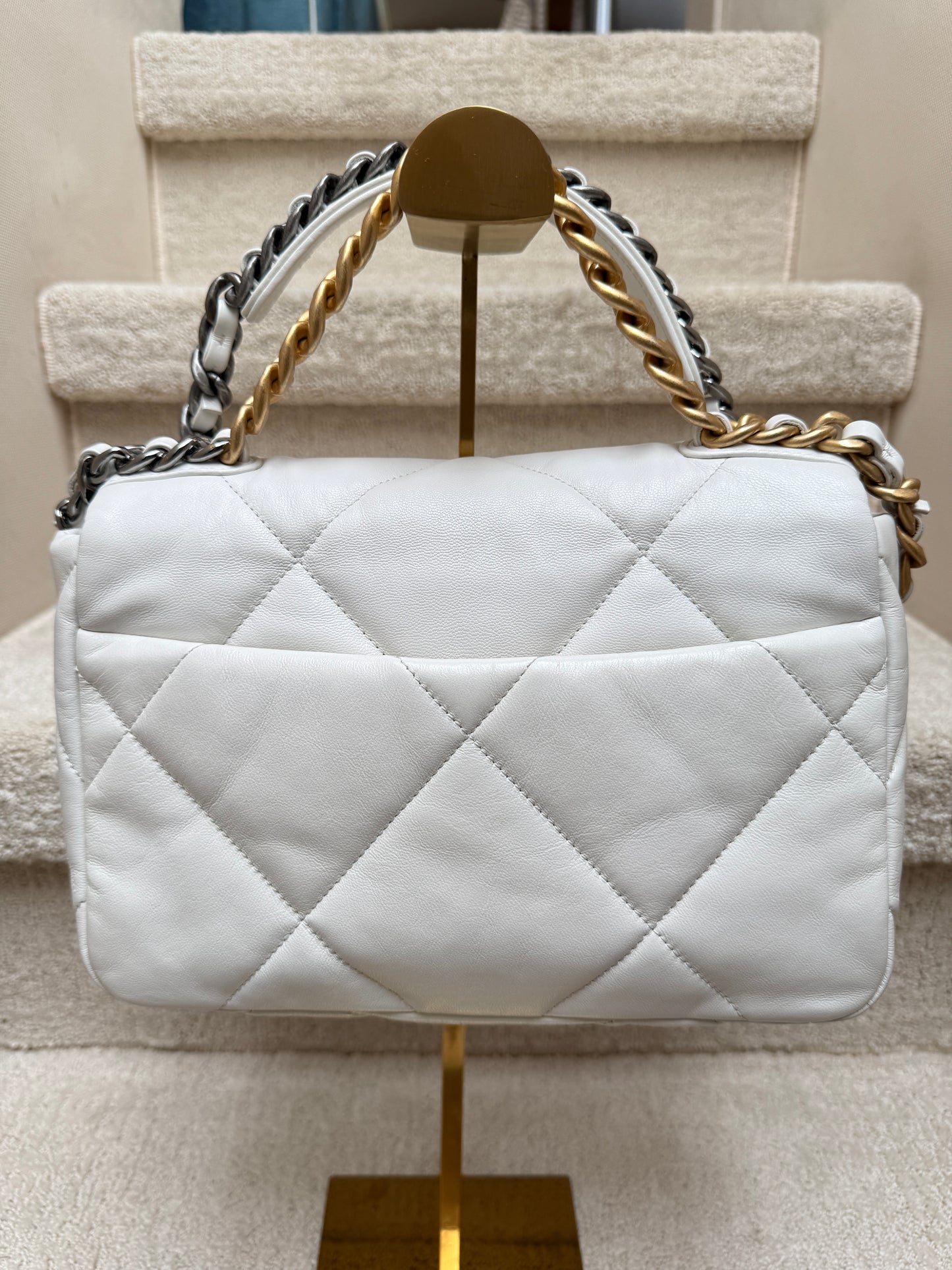 Rear view of chanel 19 white leather handbag preowned