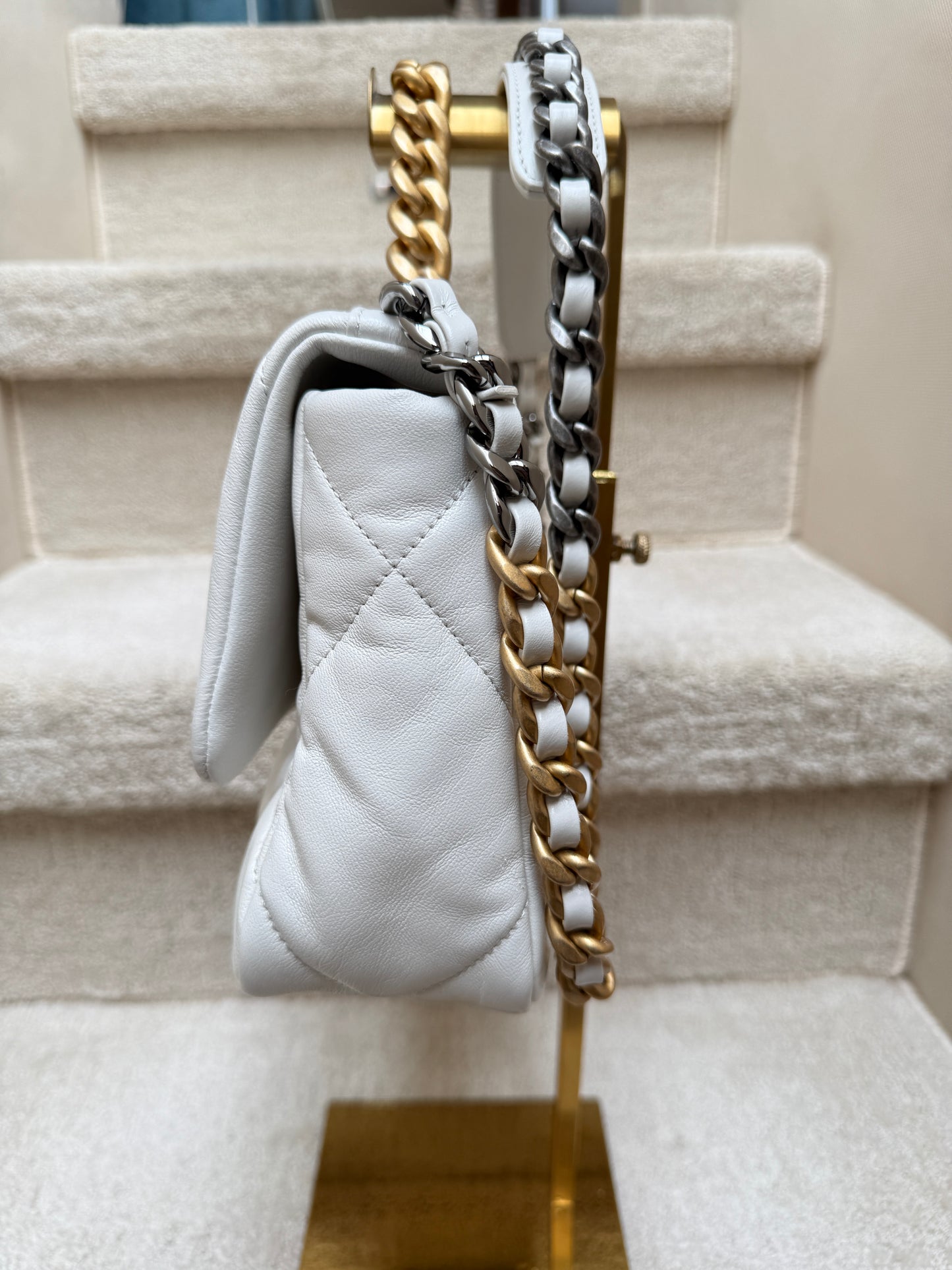 Side profile view of chanel 19 showing pillowy soft leather and clean edges