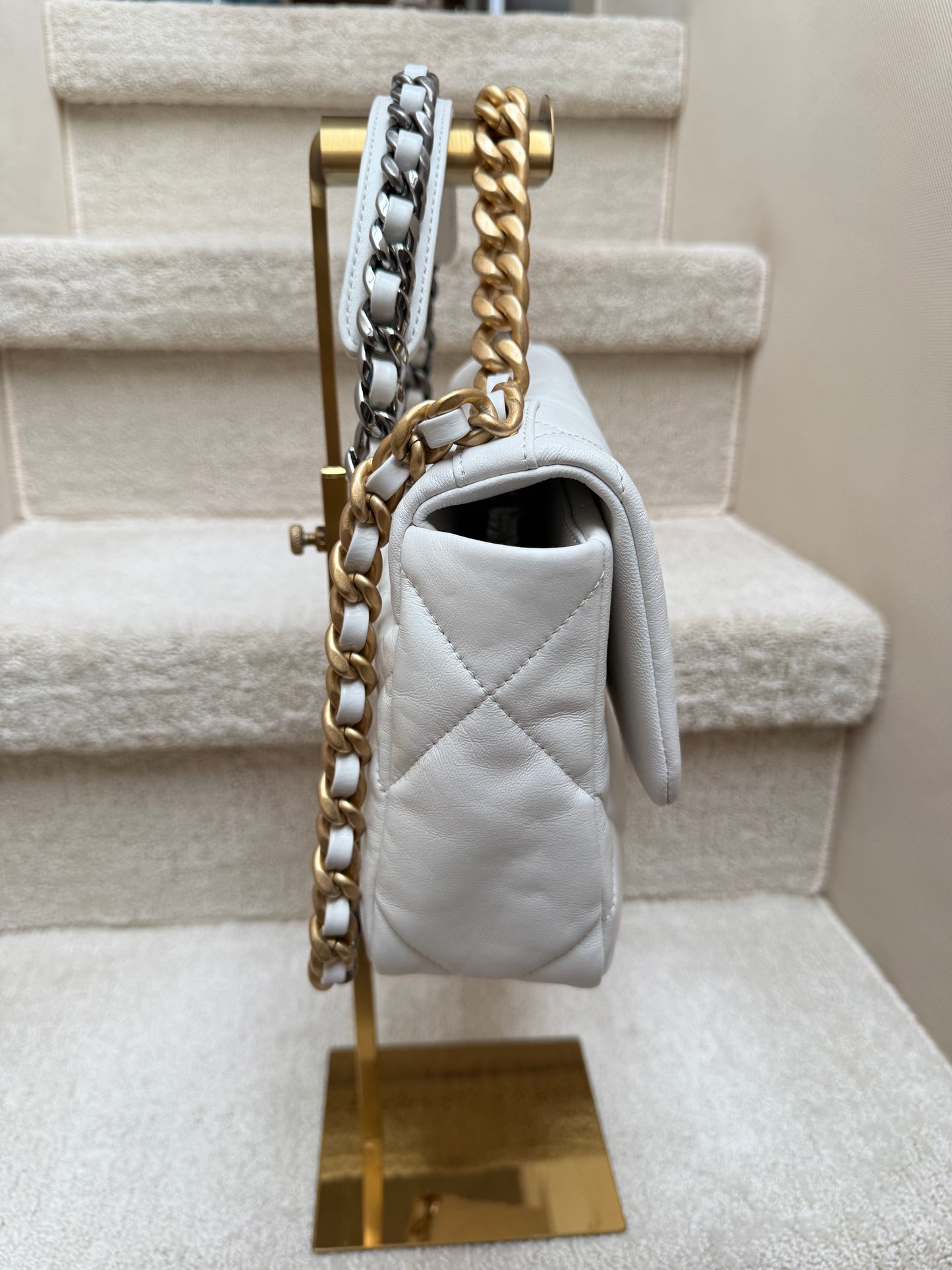 chanel 19 side view of white leather and gold hardware