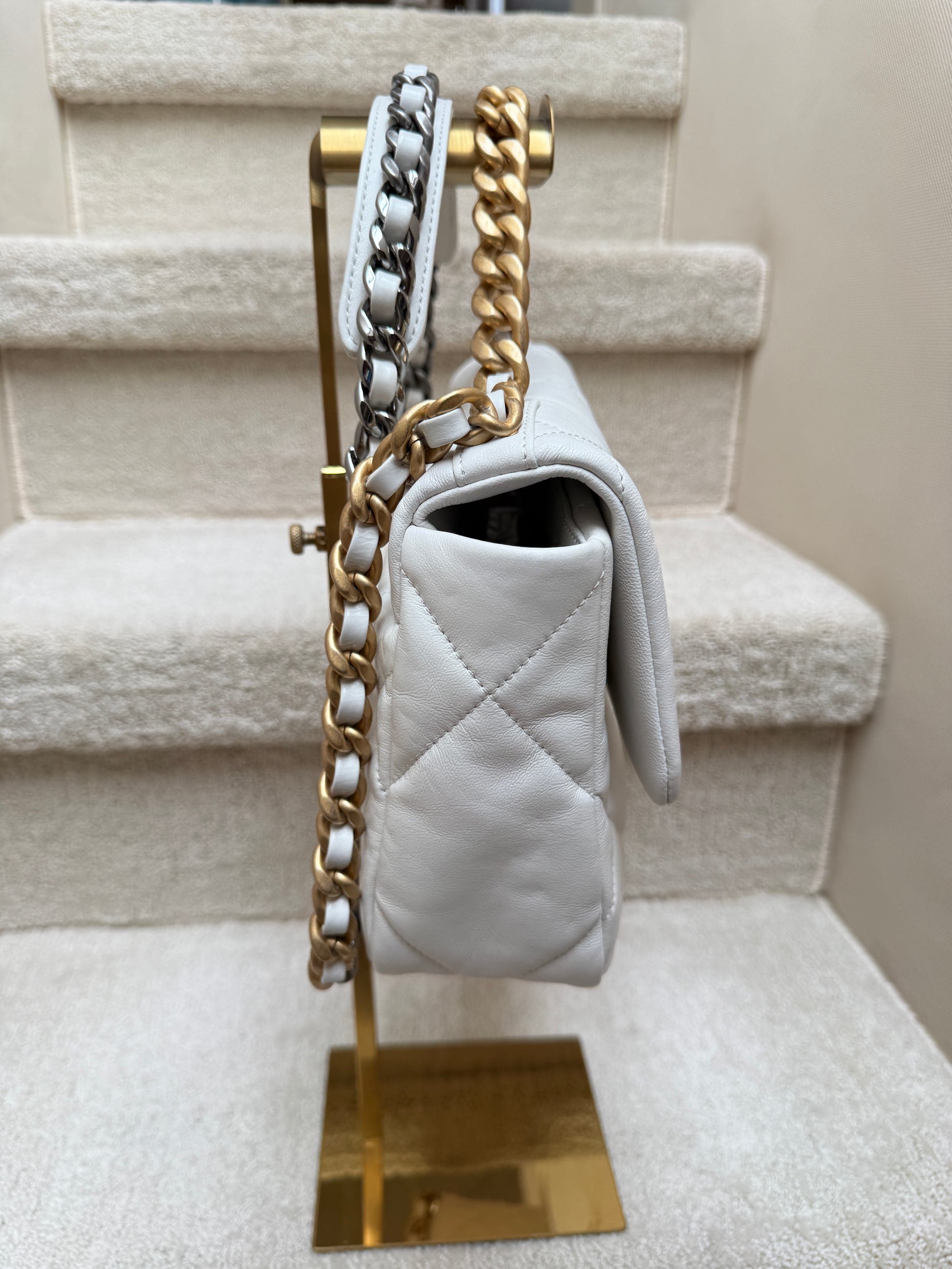 chanel 19 side view of white leather and gold hardware
