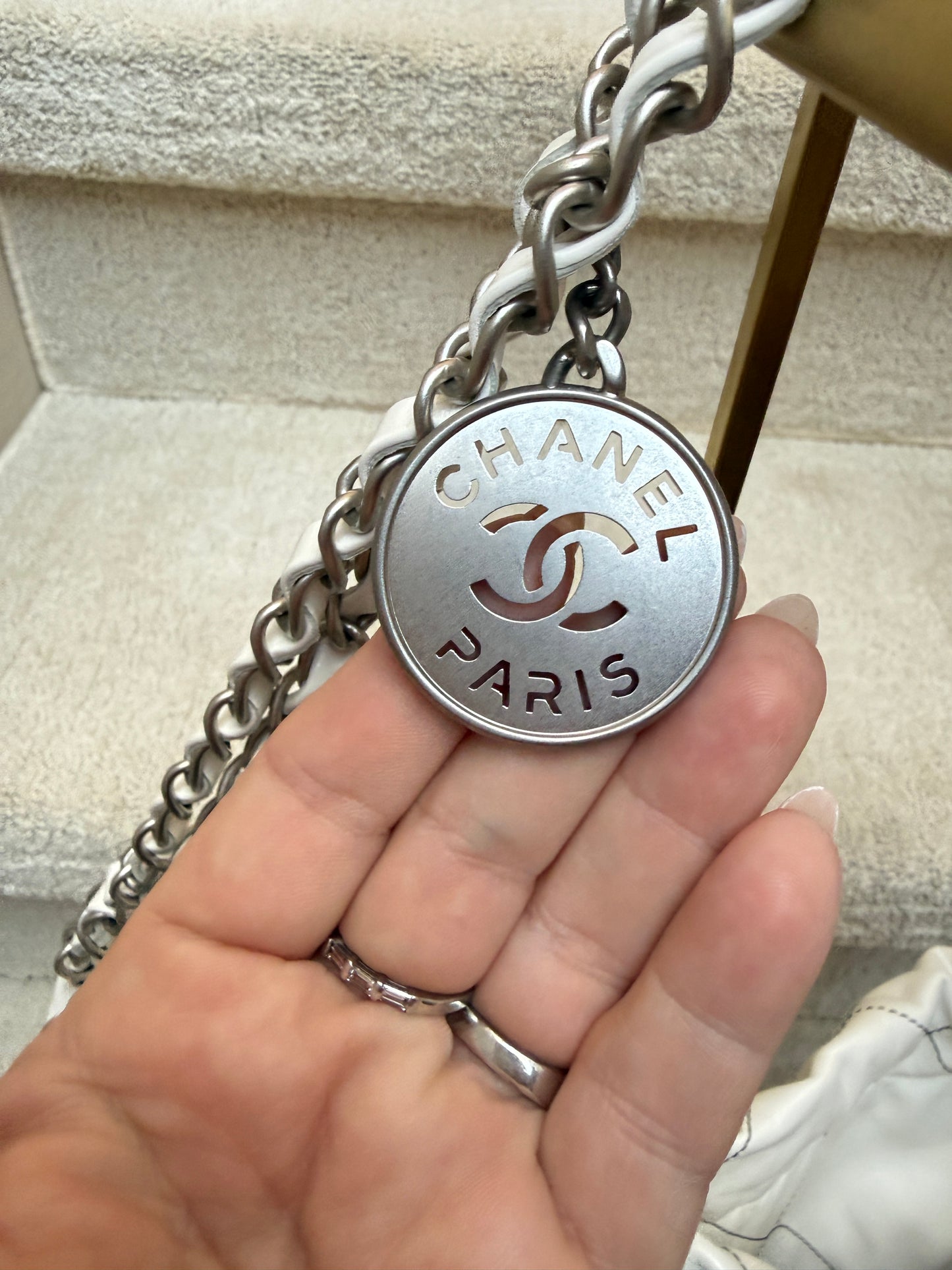 Closeup of chanel cc medallion on chanel 22 handbag