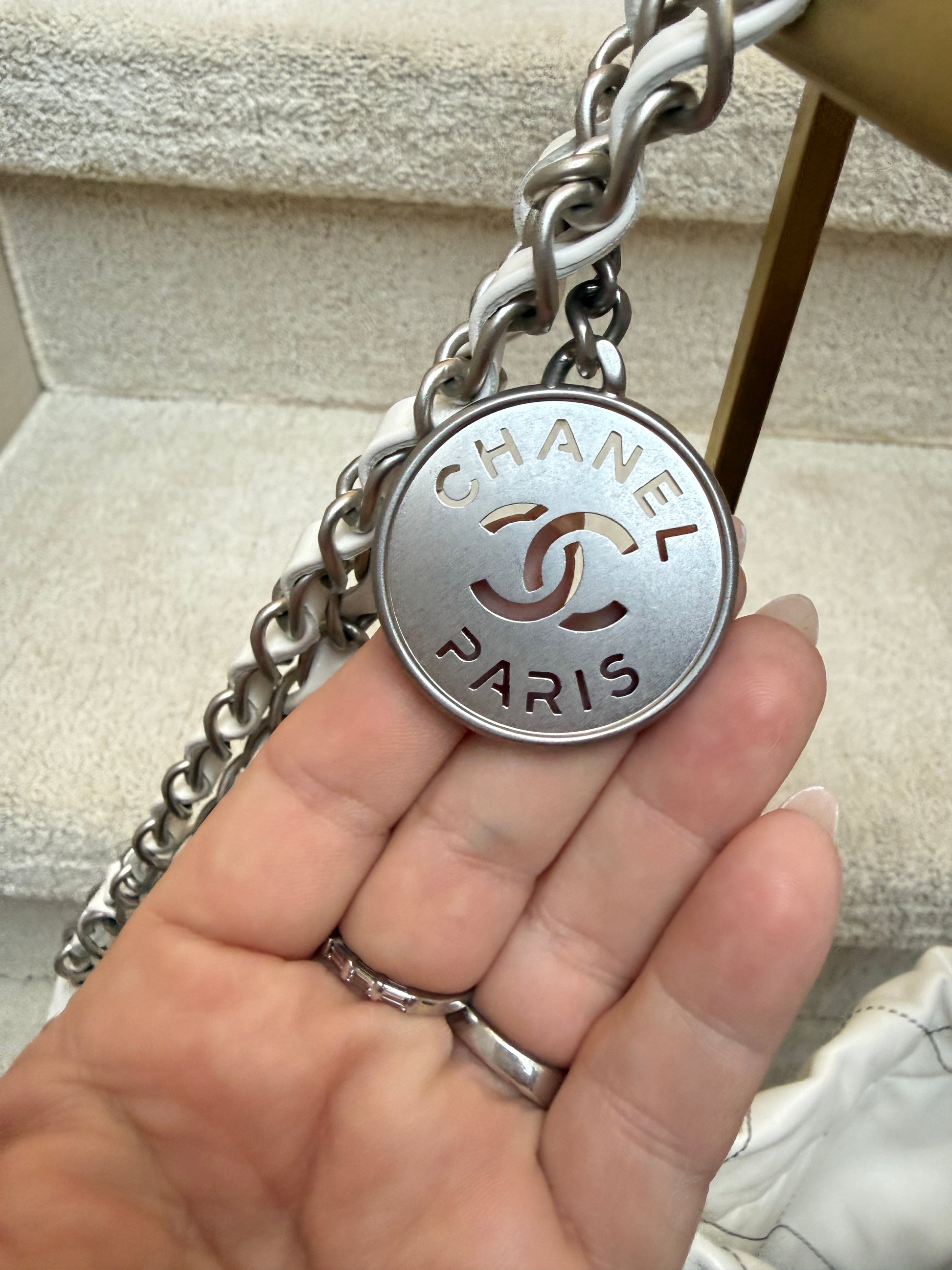 Closeup of chanel cc medallion on chanel 22 handbag