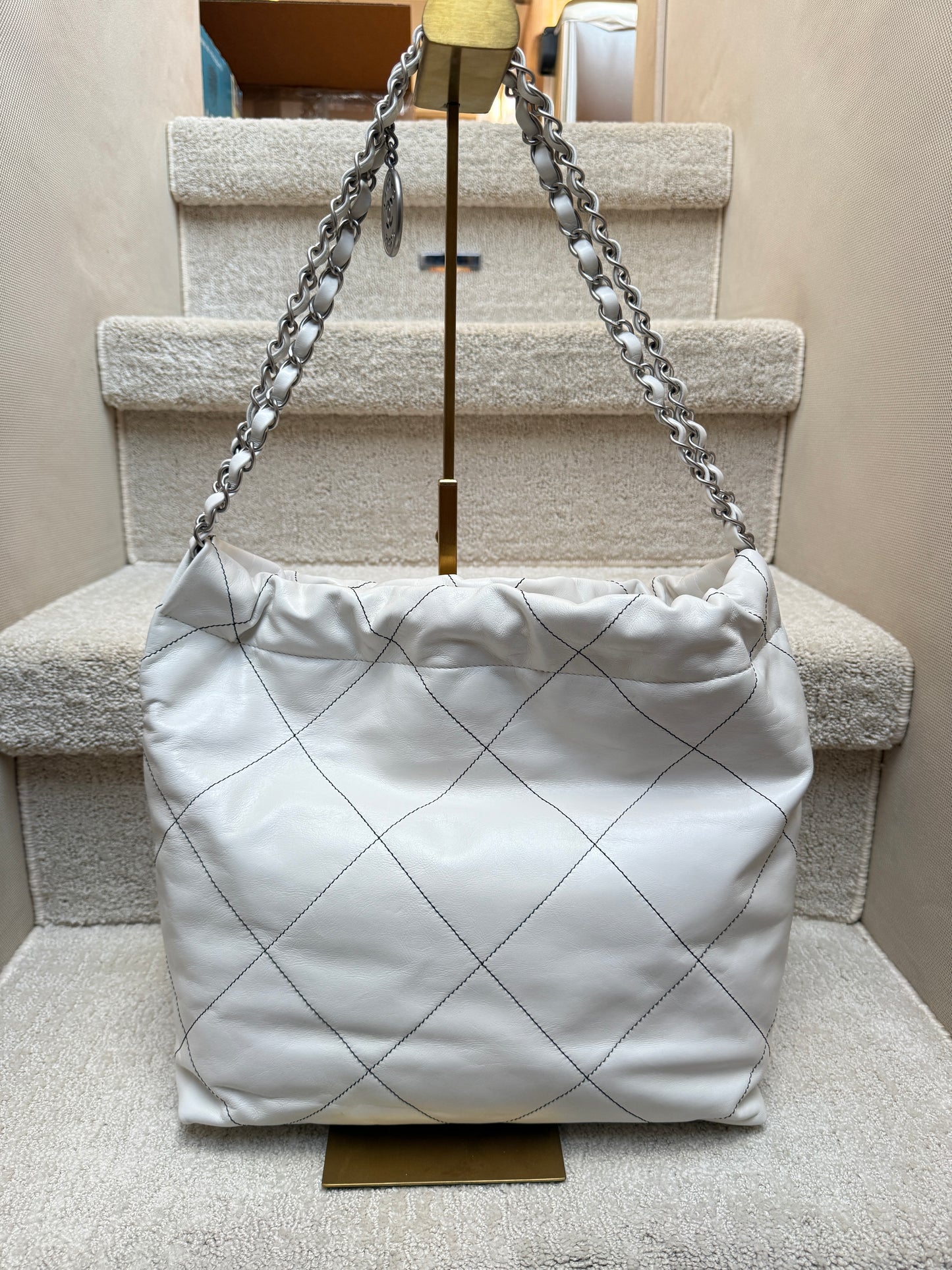 Chanel 22 in white with black stitching view of back side of hobo bag