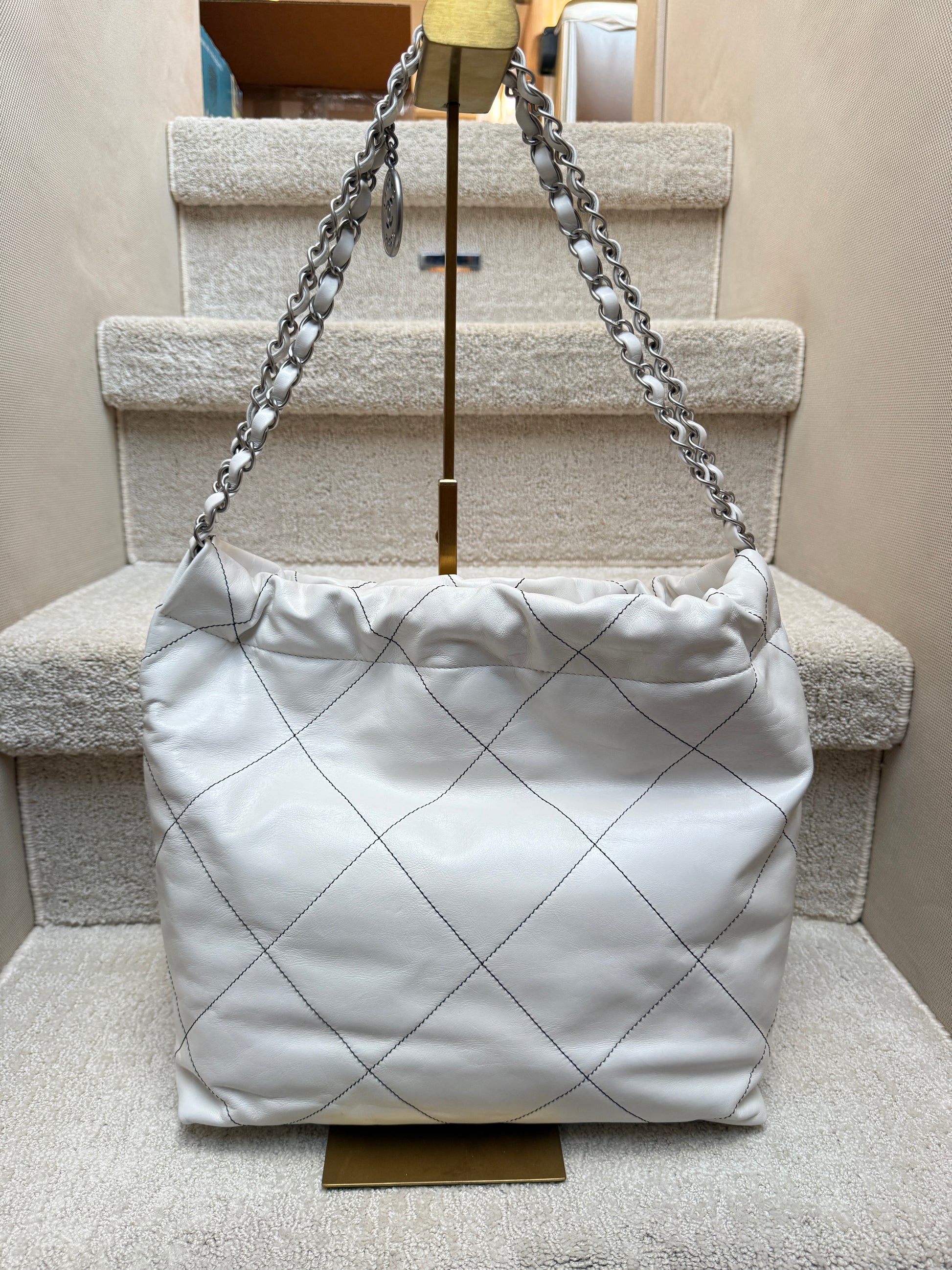 Chanel 22 in white with black stitching view of back side of hobo bag