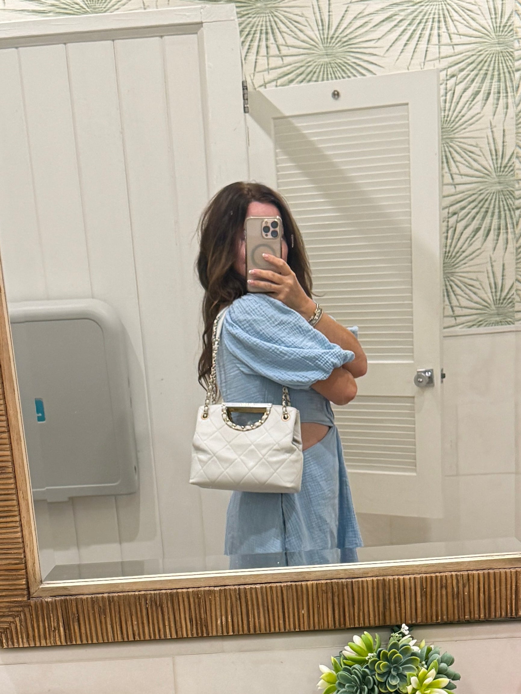Chanel caviar shoulder bag shown carried on womans shoulder