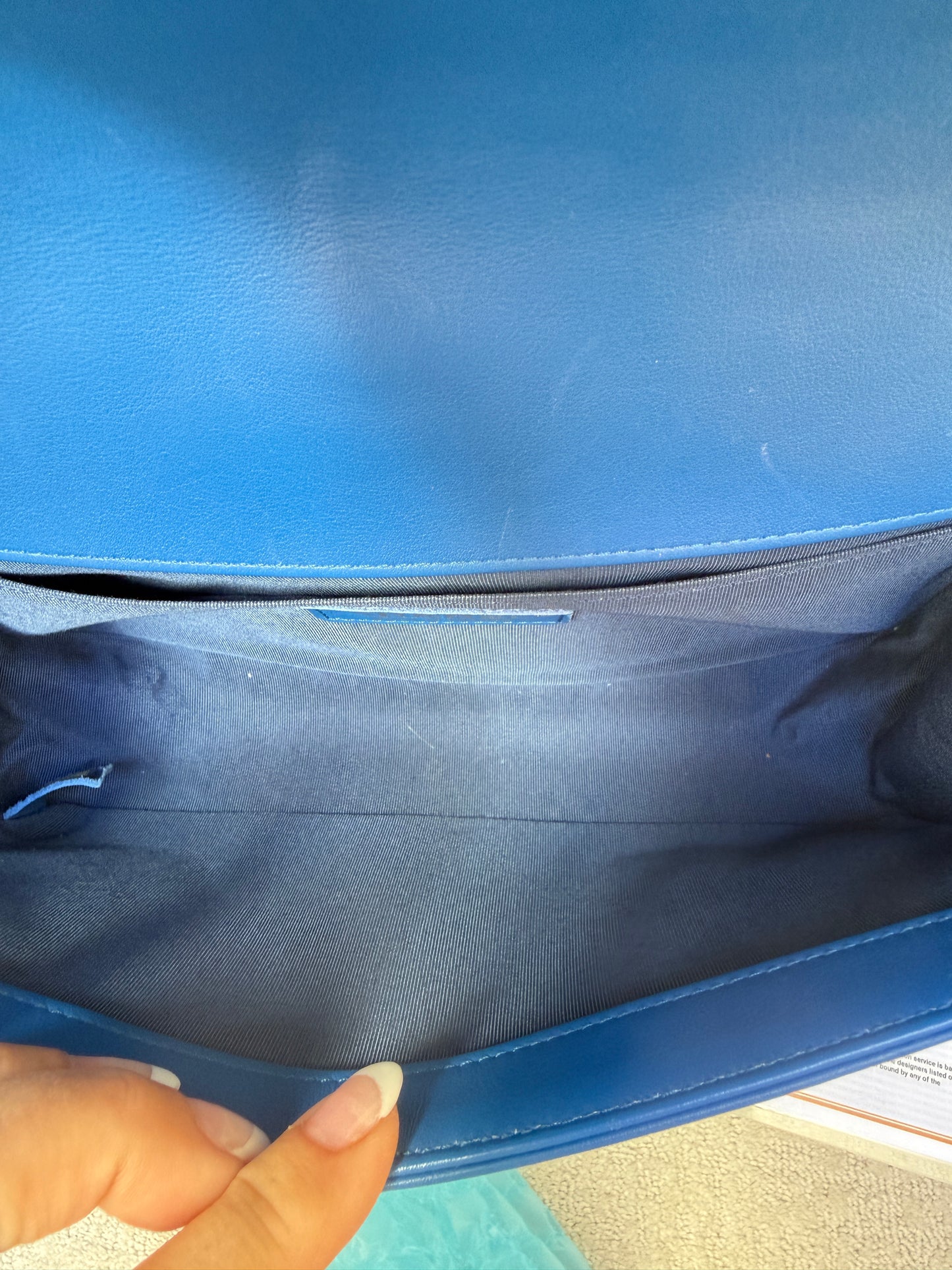Close up of interior of chanel boy bag with slip pocket clean blue