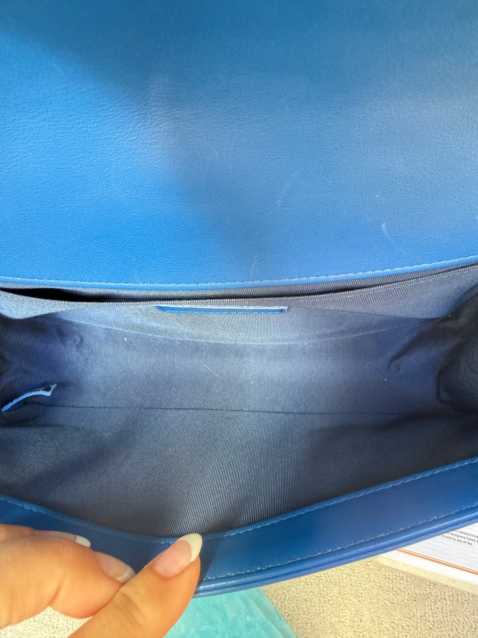 Close up of interior of chanel boy bag with slip pocket clean blue