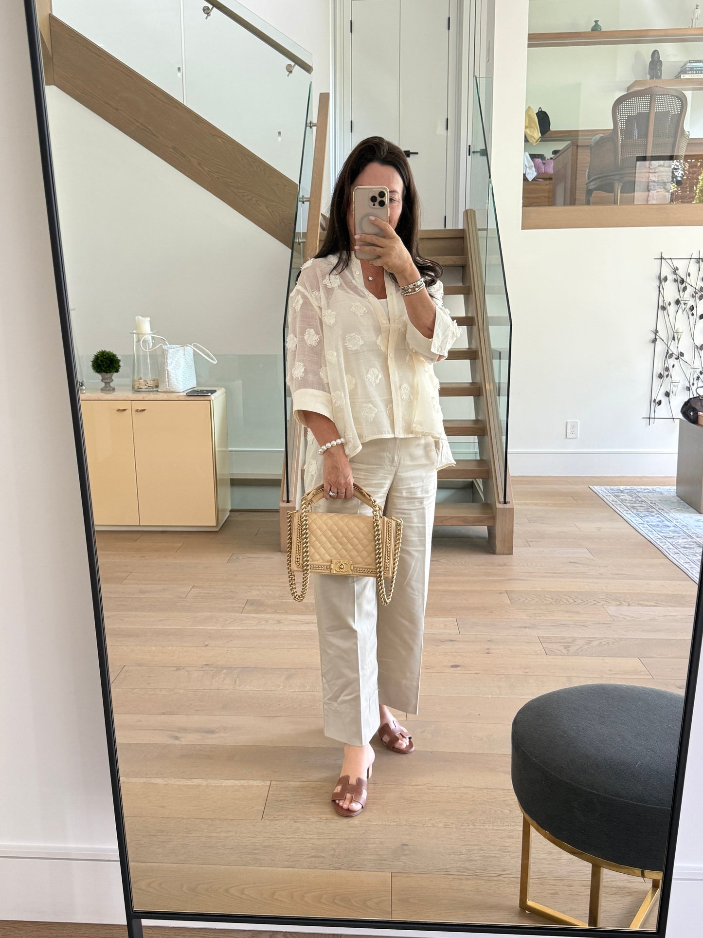 chanel boy bag medium with top handle in beige leather with gold hardware authentic and pre-owned from purseonalshopper shown carried by top handle by woman