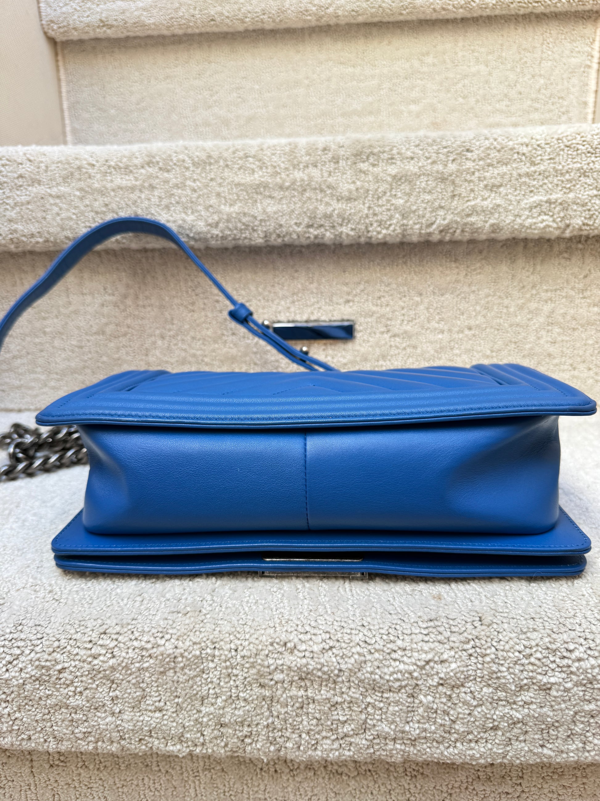 close up of bottom of chanel boy bag in blue