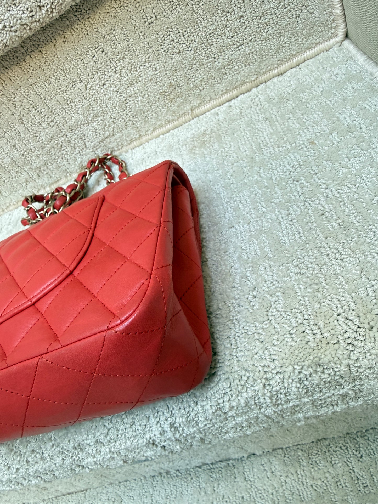 close up of back right corner of chanel classic double flap in red