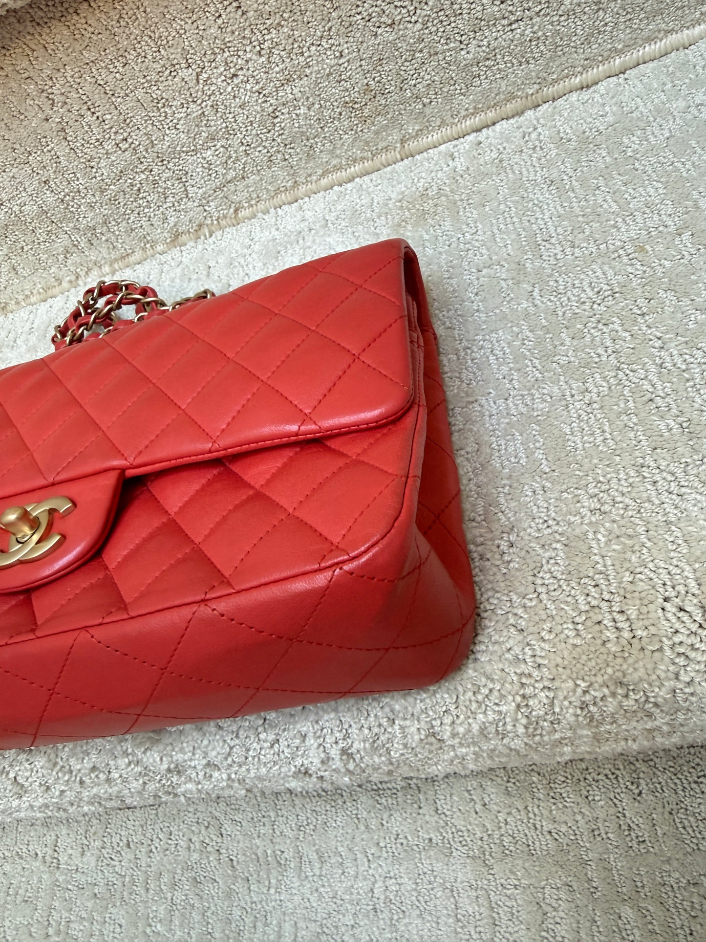 chanel classic double flap in red lambskin closeup of front right corner