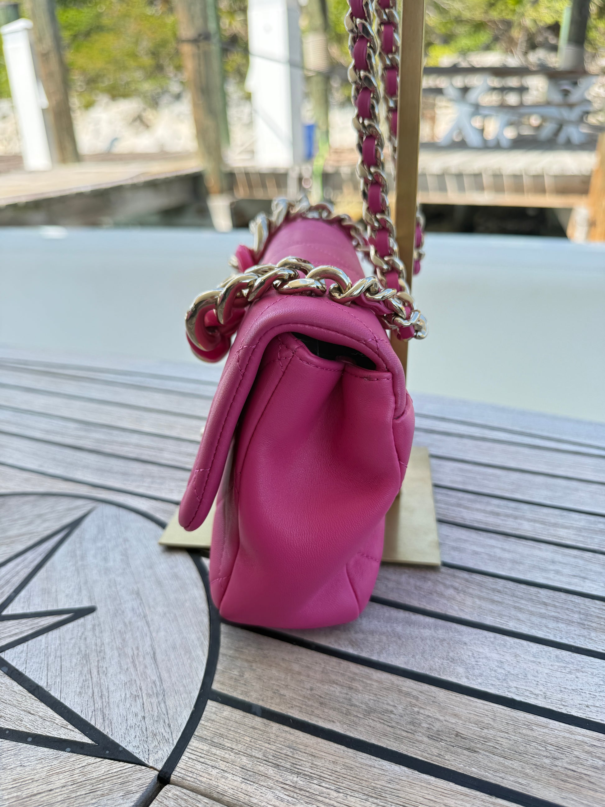 chanel classic flap medium pink gold hardware view of side of purse