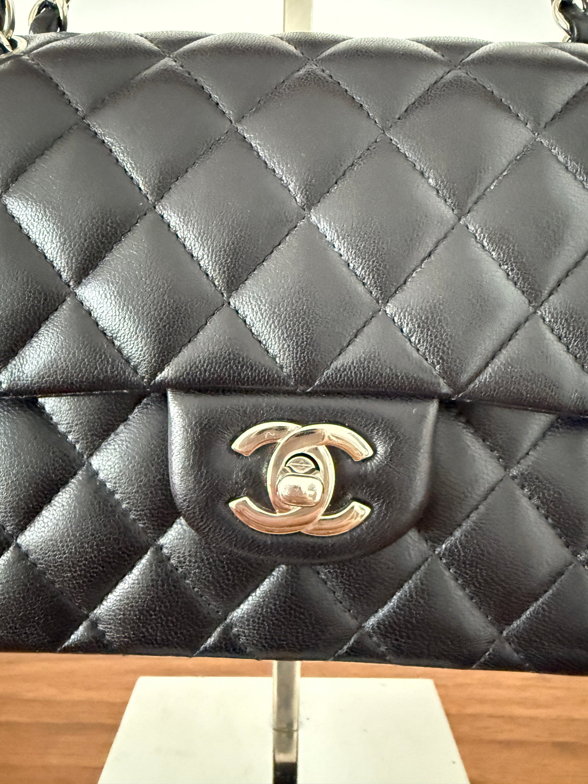 Chanel double classic flap in small black lambskin leather closeup of CC turn lock in silver