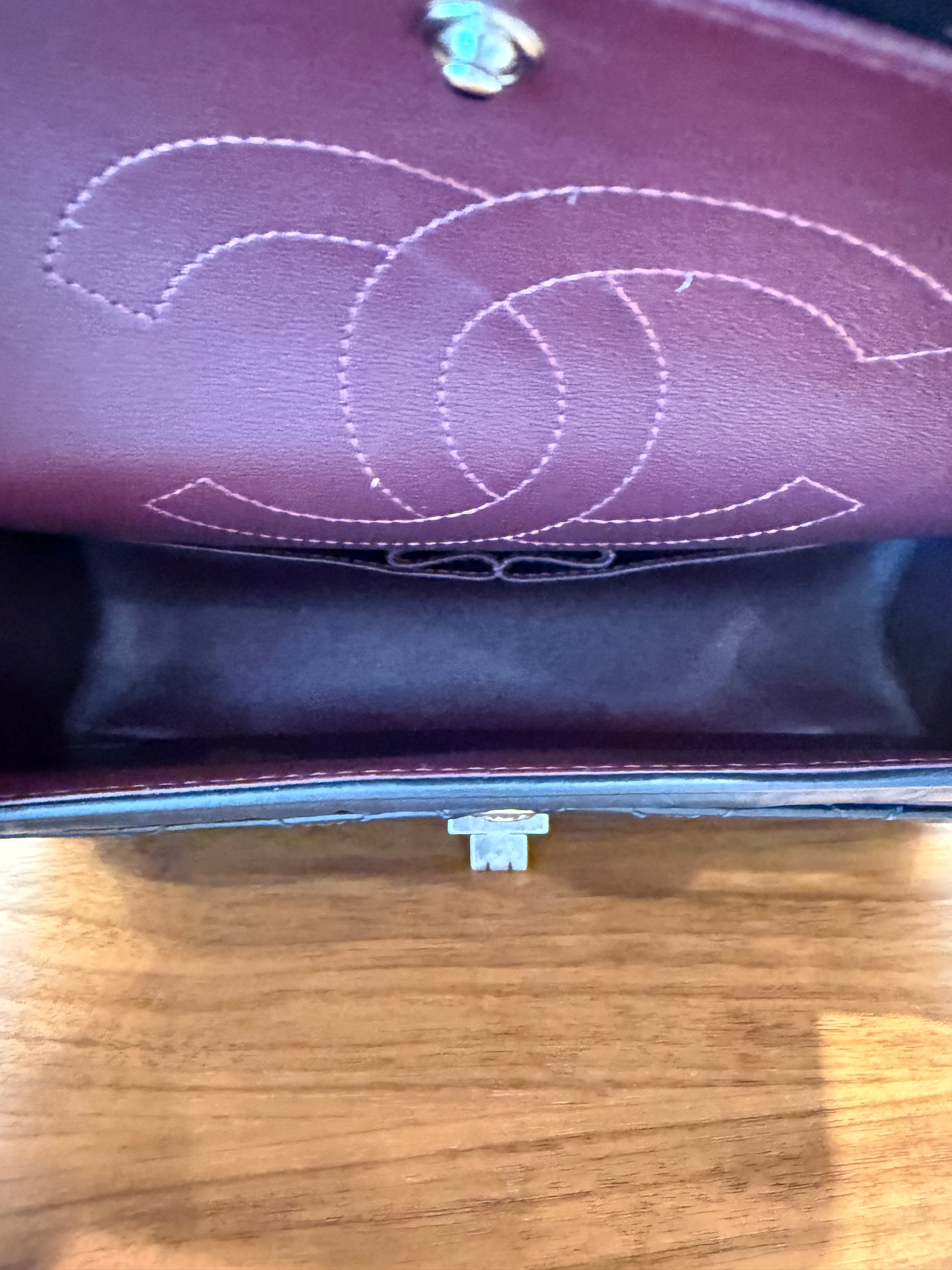 Interior view of chanel black classic flap 2.55 medium burgundy leather