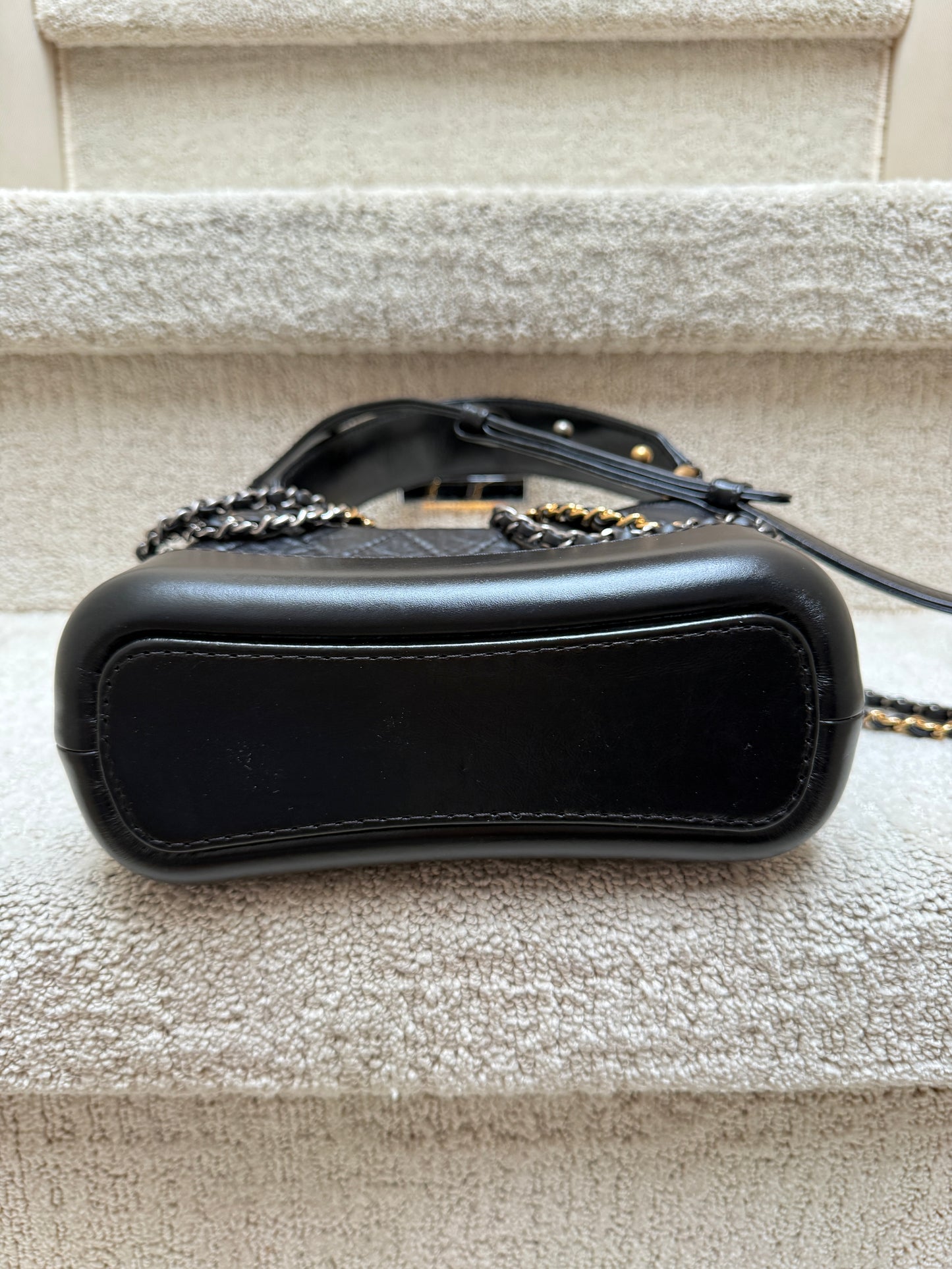 Chanel gabrielle bag in small black showing bottom of bag is like new 