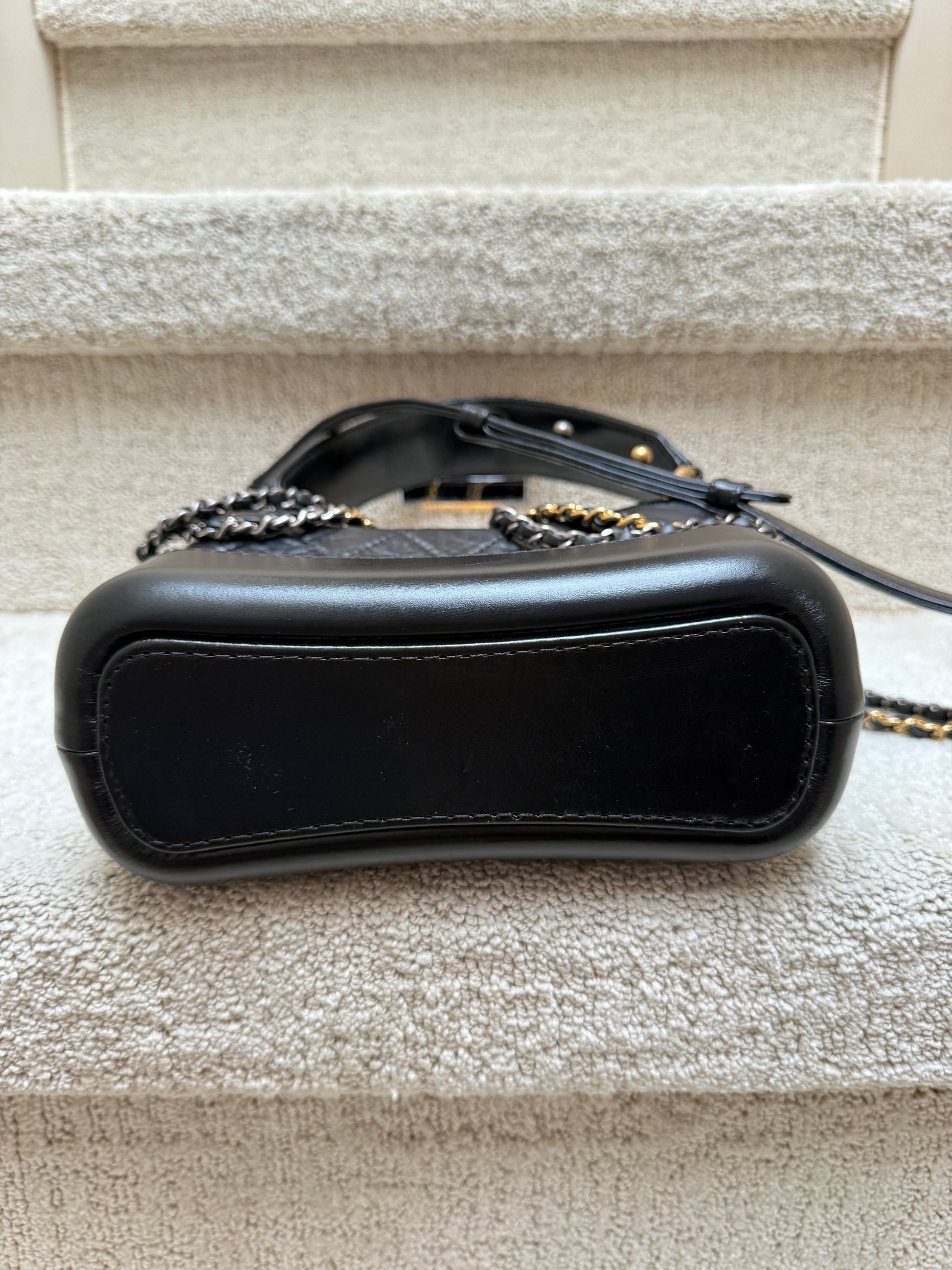 Chanel gabrielle bag in small black showing bottom of bag is like new 