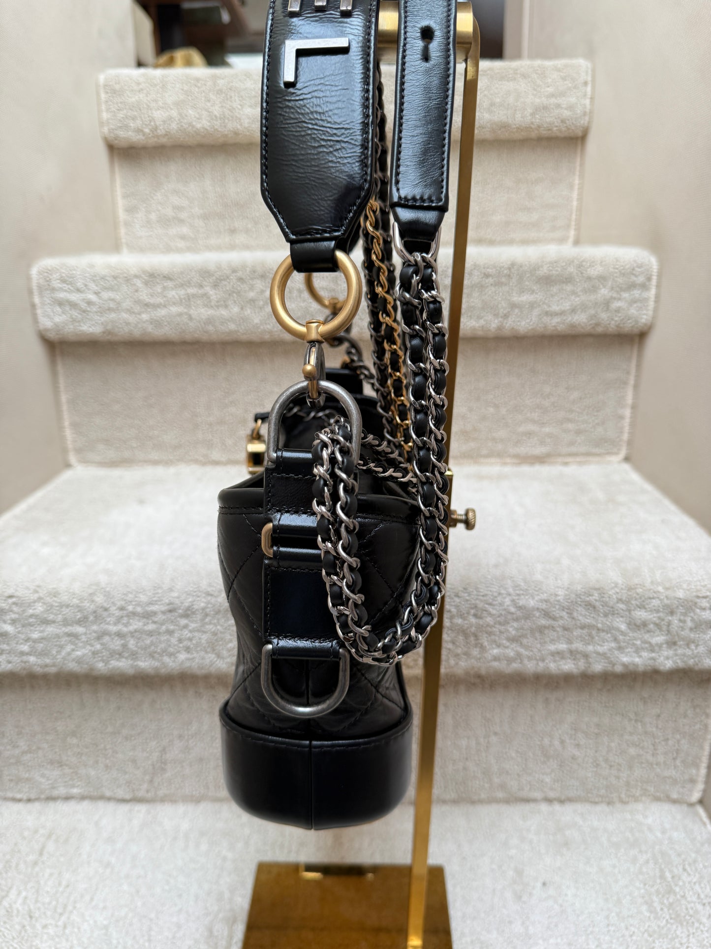 chanel gabrielle handbag in small size black showing the clean second side view.
