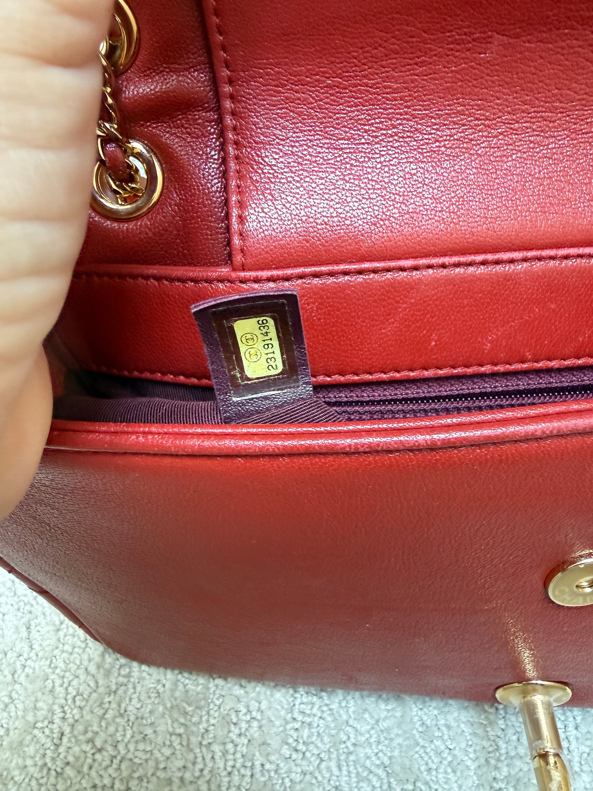 close up of serial number on chanel medium flap in red and gold
