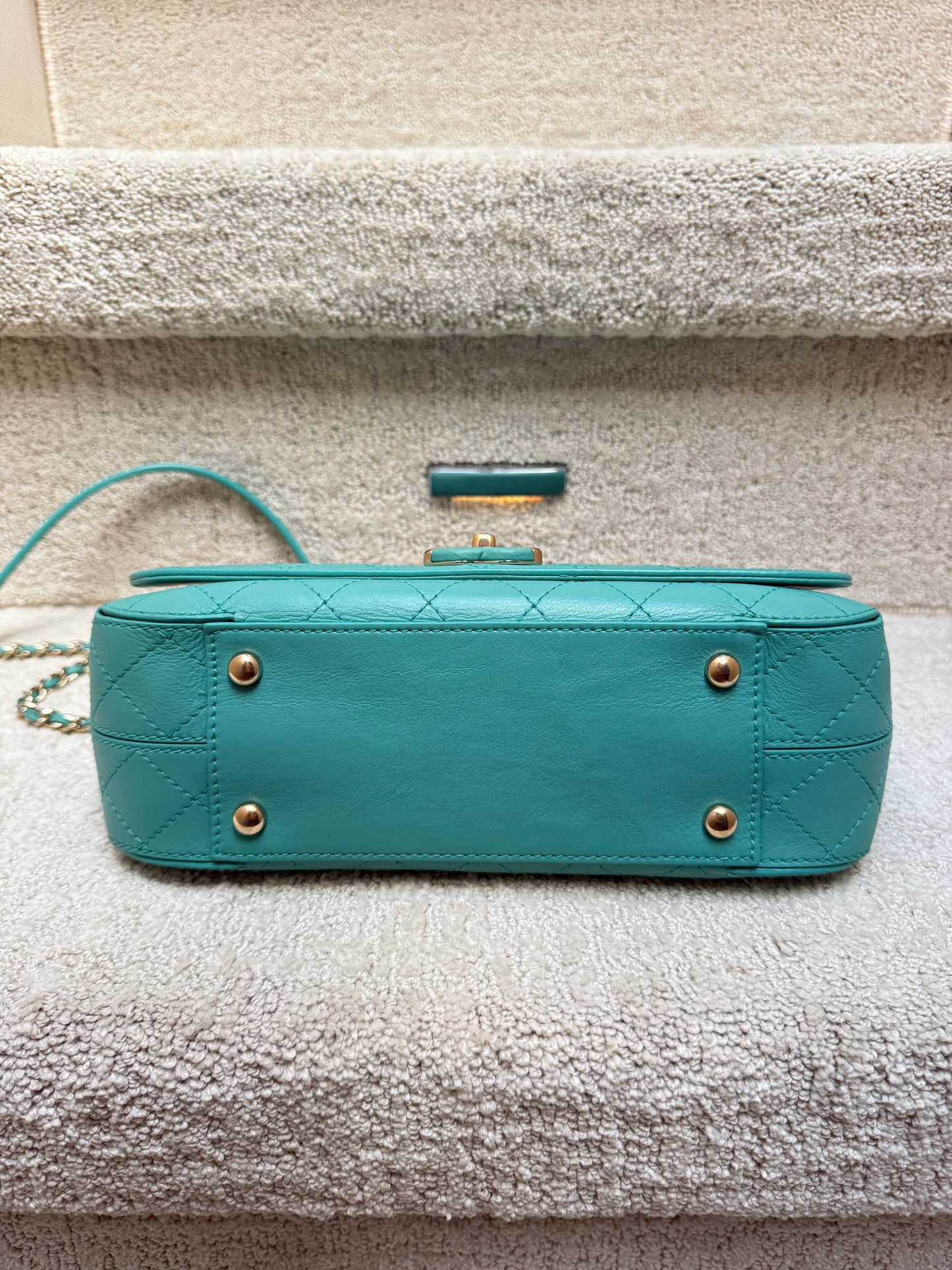 Chanel medium calfskin classic flap view of bottom of handbag with feet
