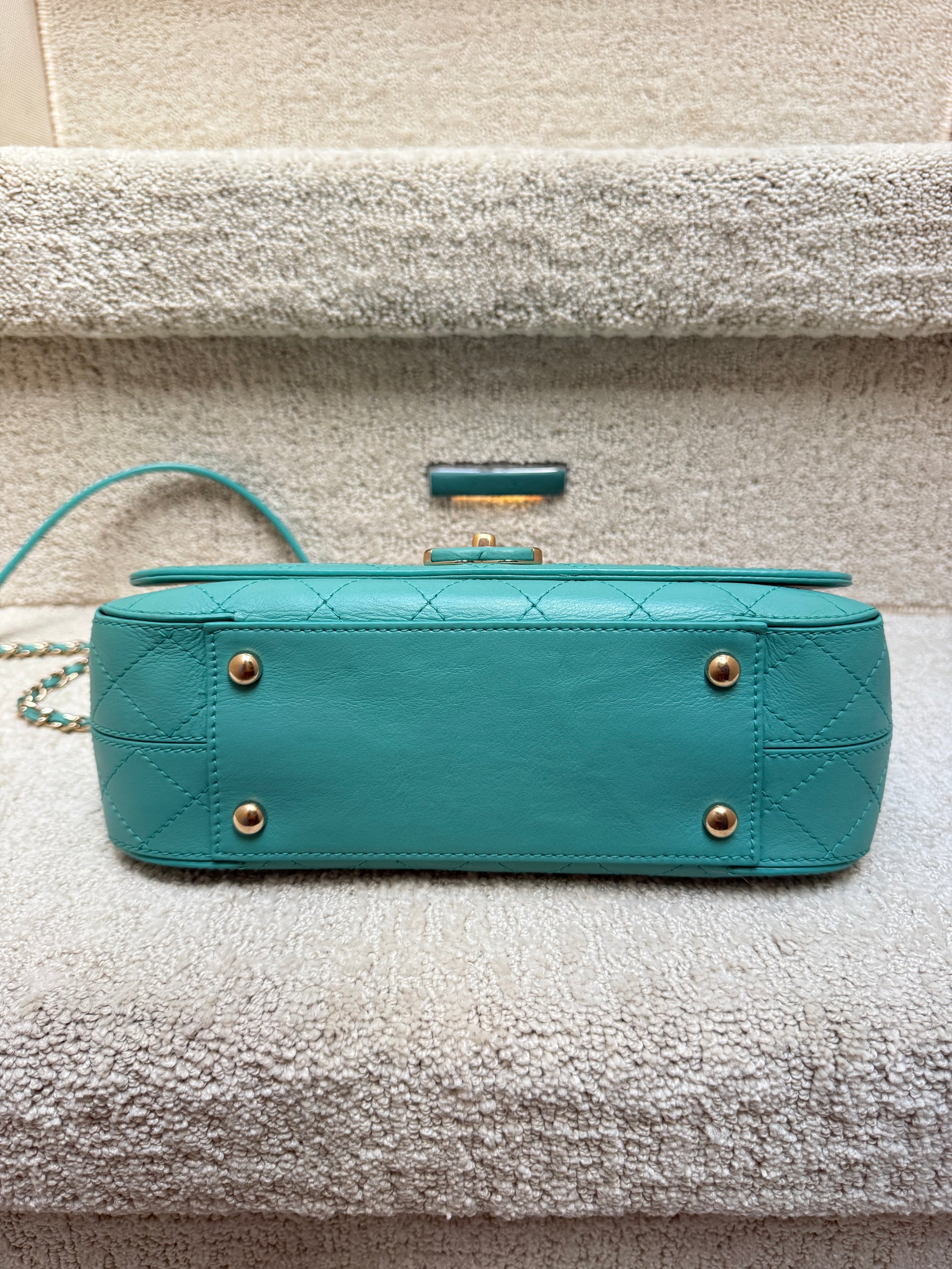 Chanel medium calfskin classic flap view of bottom of handbag with feet