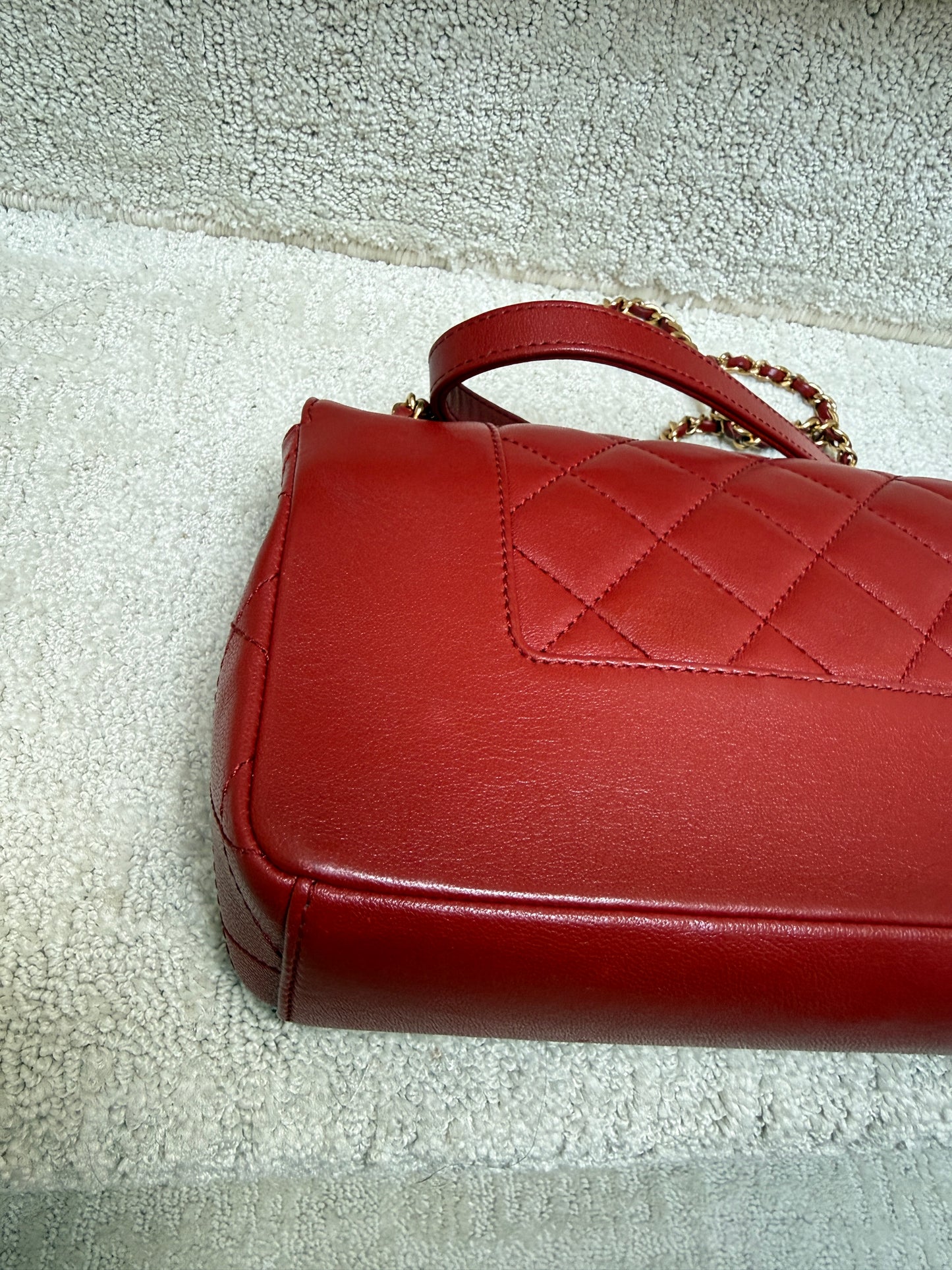 closeup of the back corner of a chanel medium flap in red leather offered for sale from purseonalshopper