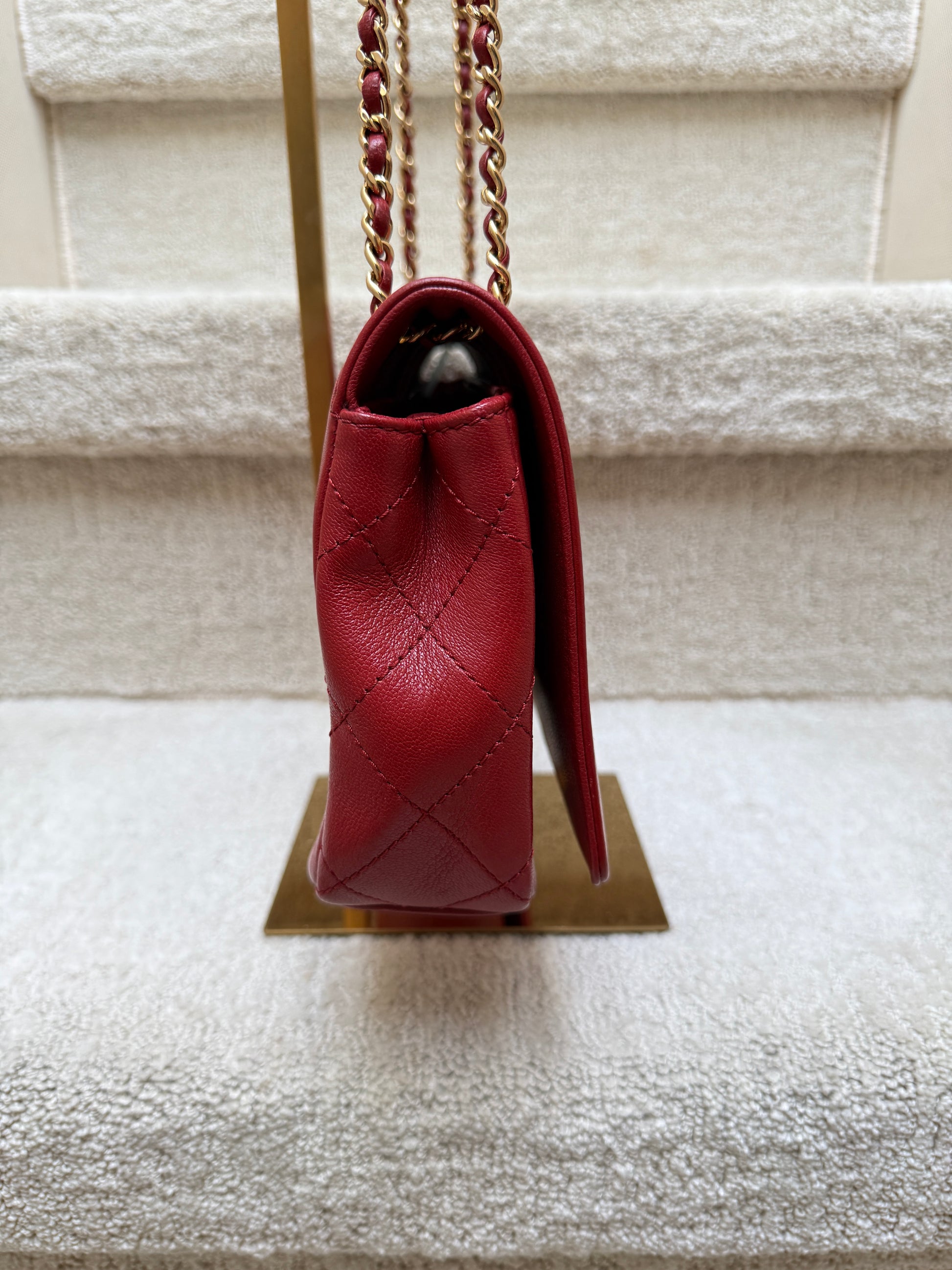 side view of chanel red medium flap