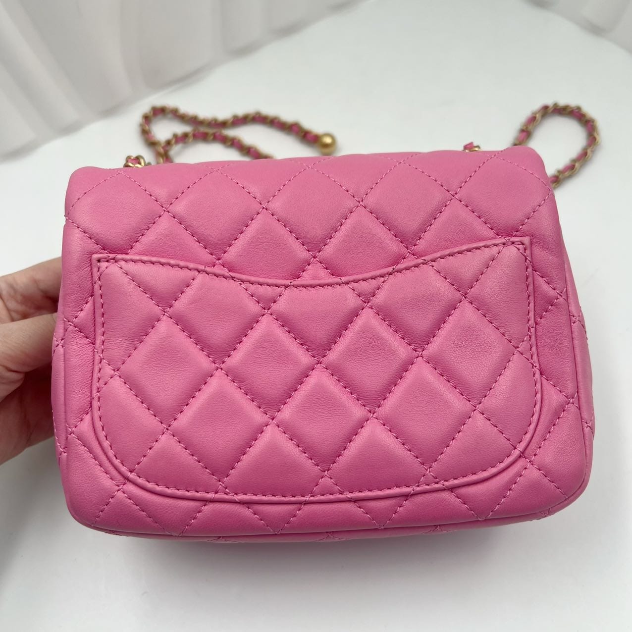 phtot of the back of a chanel pearl crush handbag showing back pocket