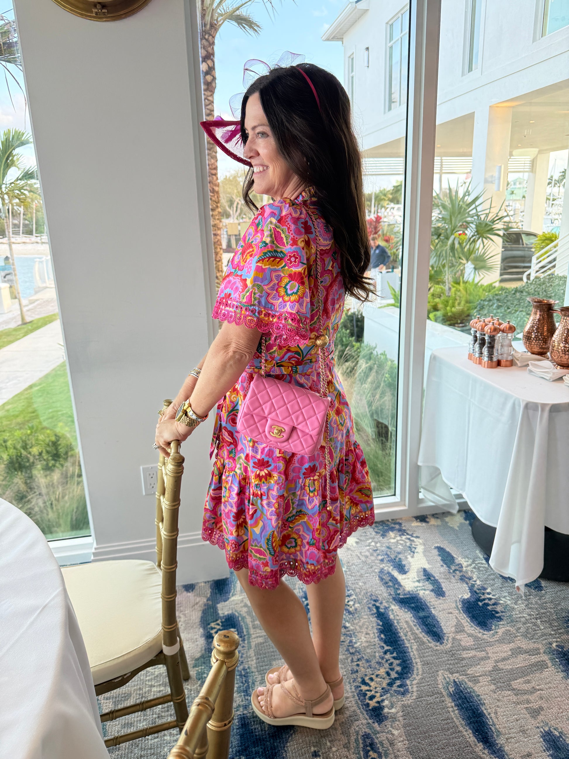 Chanel pearl crush in pink on woman's shoulder with adjustable gold strap