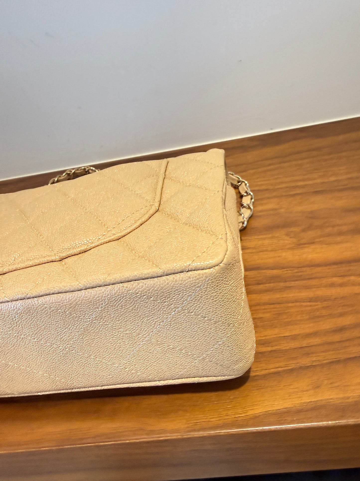 Chanel small double classic flap in beige caviar leather close up of back right corner