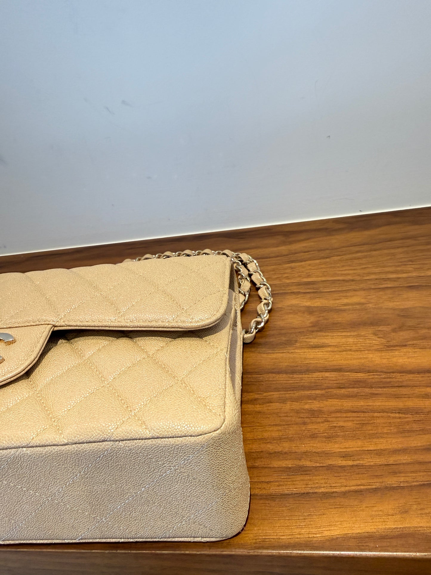 Chanel small double classic flap in beige caviar leather and this picutre is of the front left corner