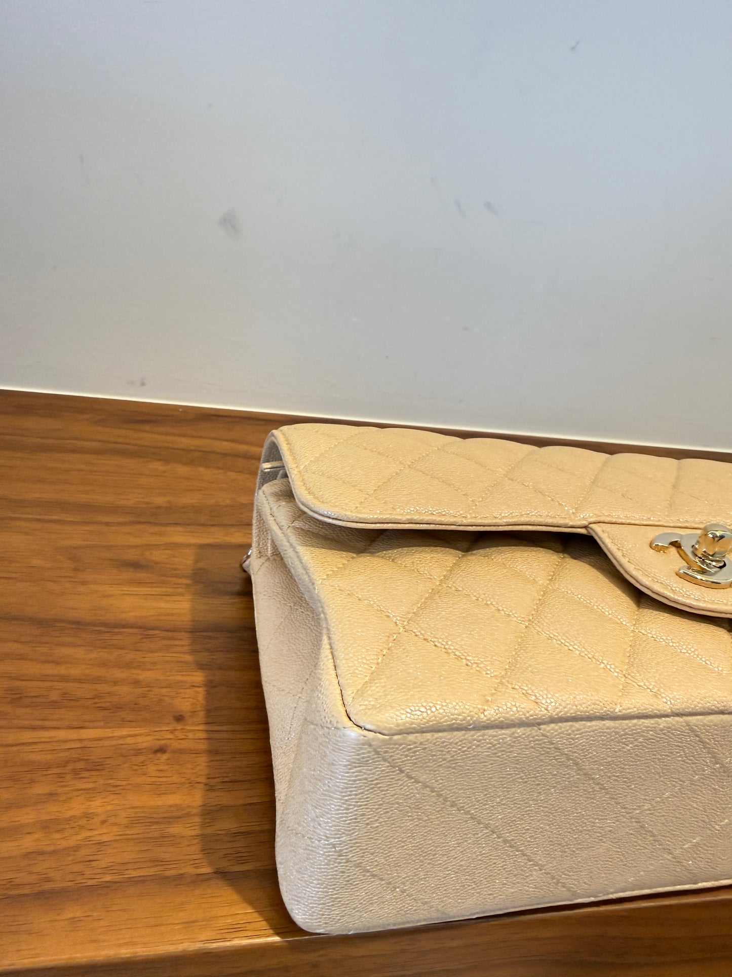Chanel small double classic flap in irridescent beige caviar leather front left corner closeup 