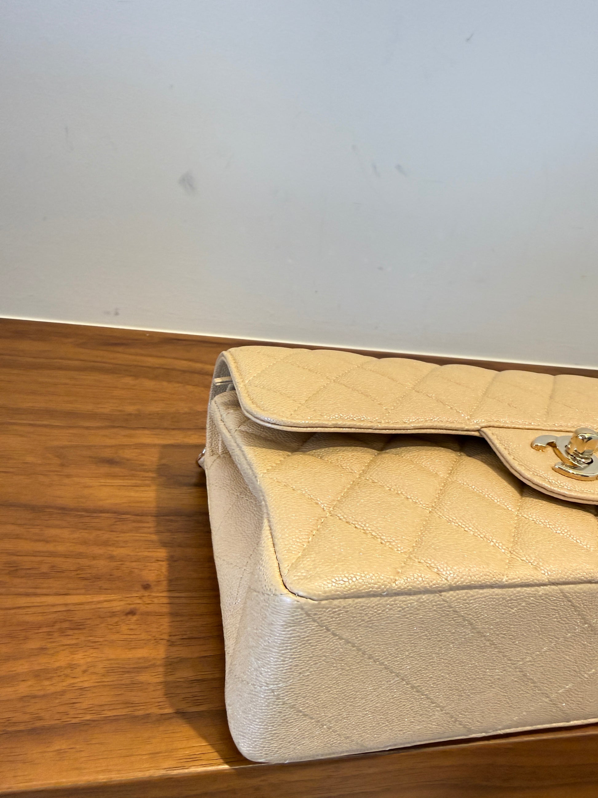 Chanel small double classic flap in irridescent beige caviar leather front left corner closeup 