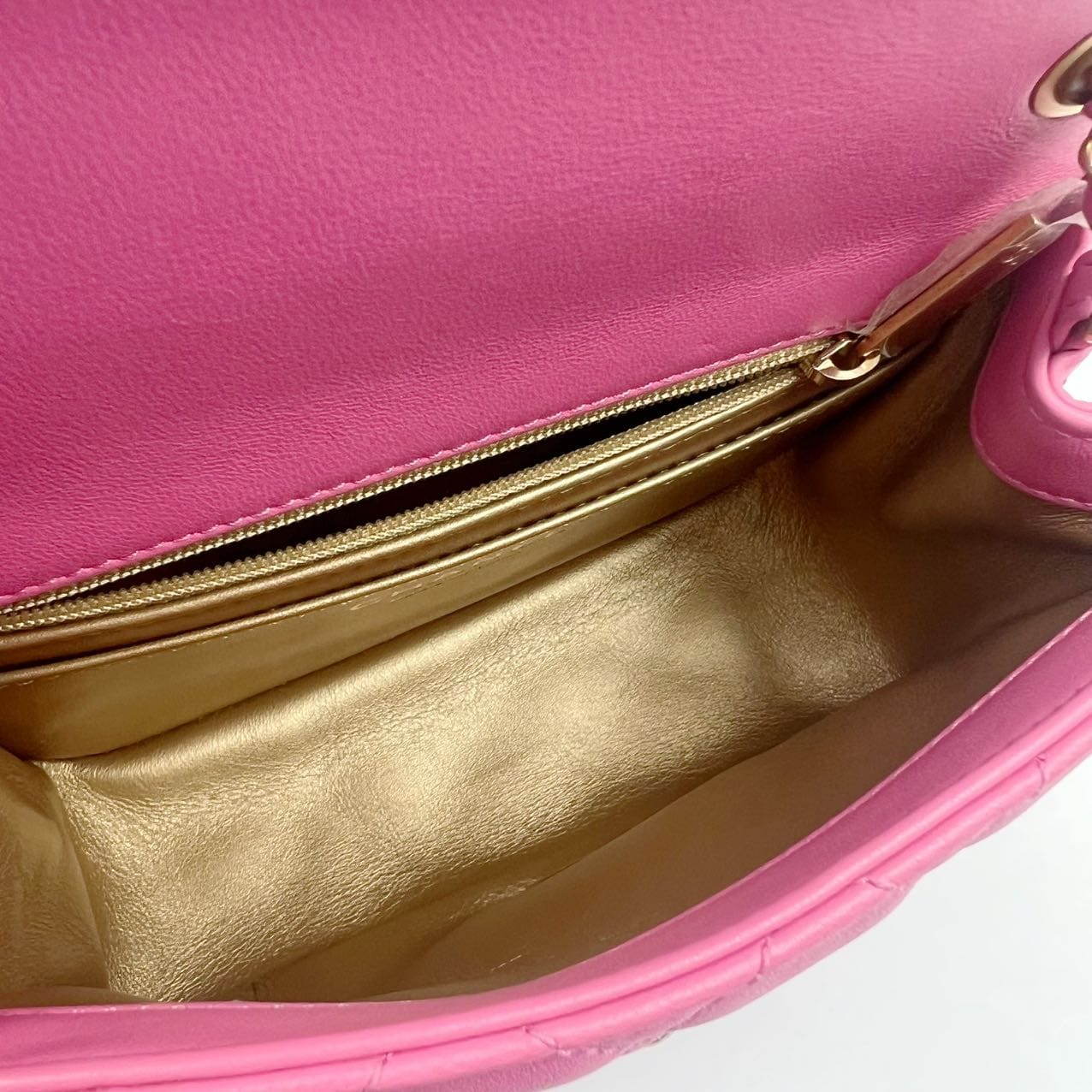 Interior of chanel mini pearl crush showing gold leather interior with zipper compartment