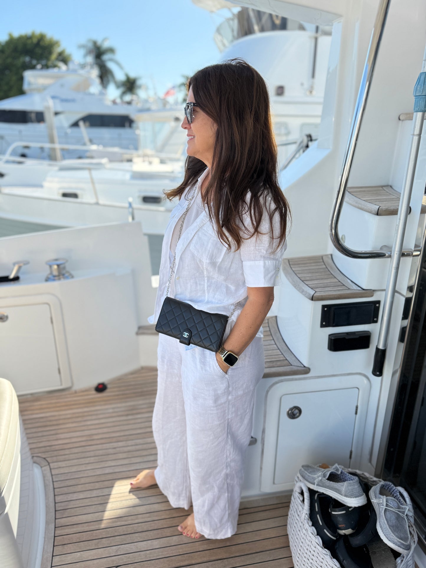 Chanel Black lambskin wallet with 3rd party chain shown on woman worn as crossbody