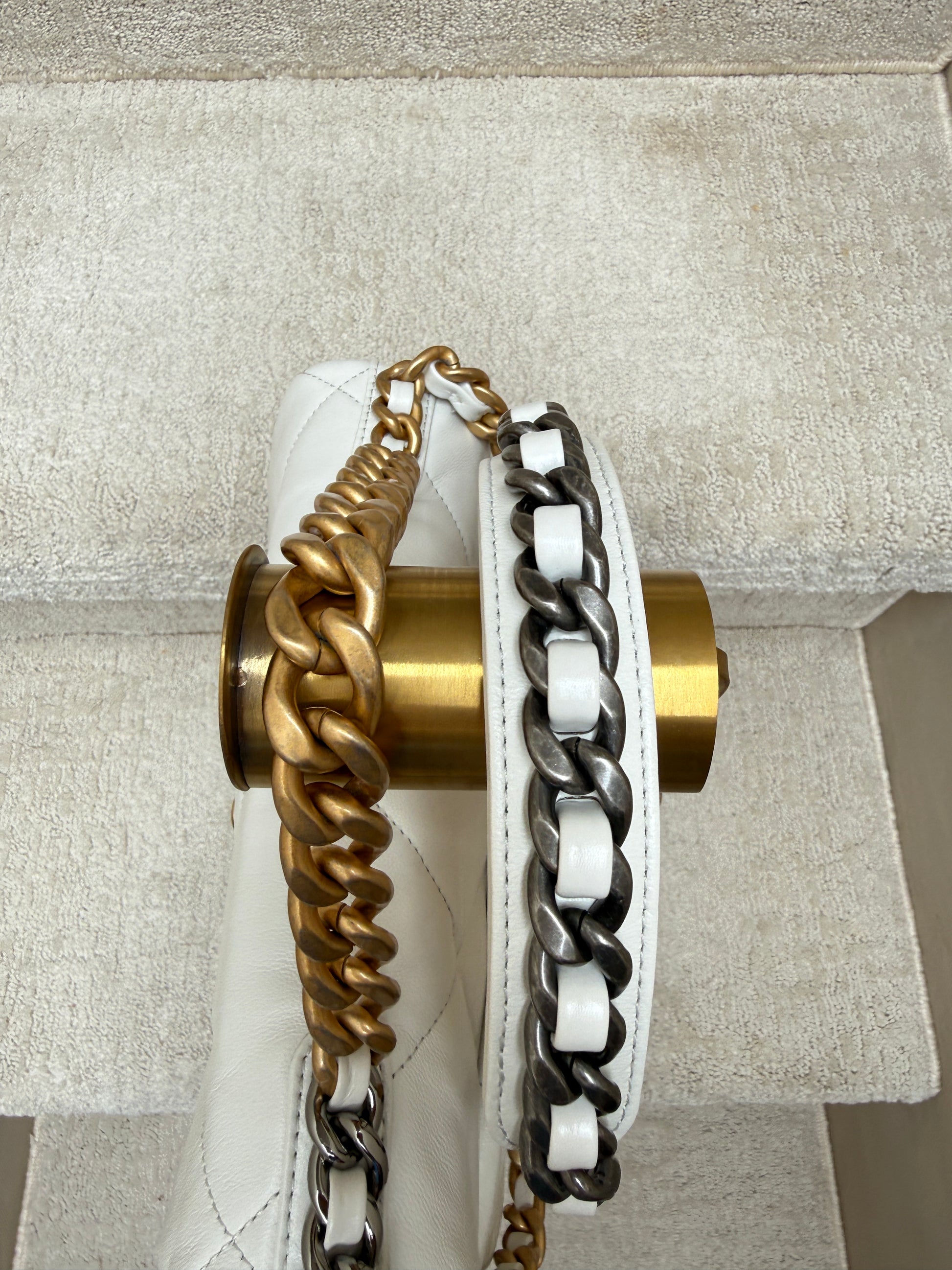 close up of hardware on the strap of the chanel 19 in white