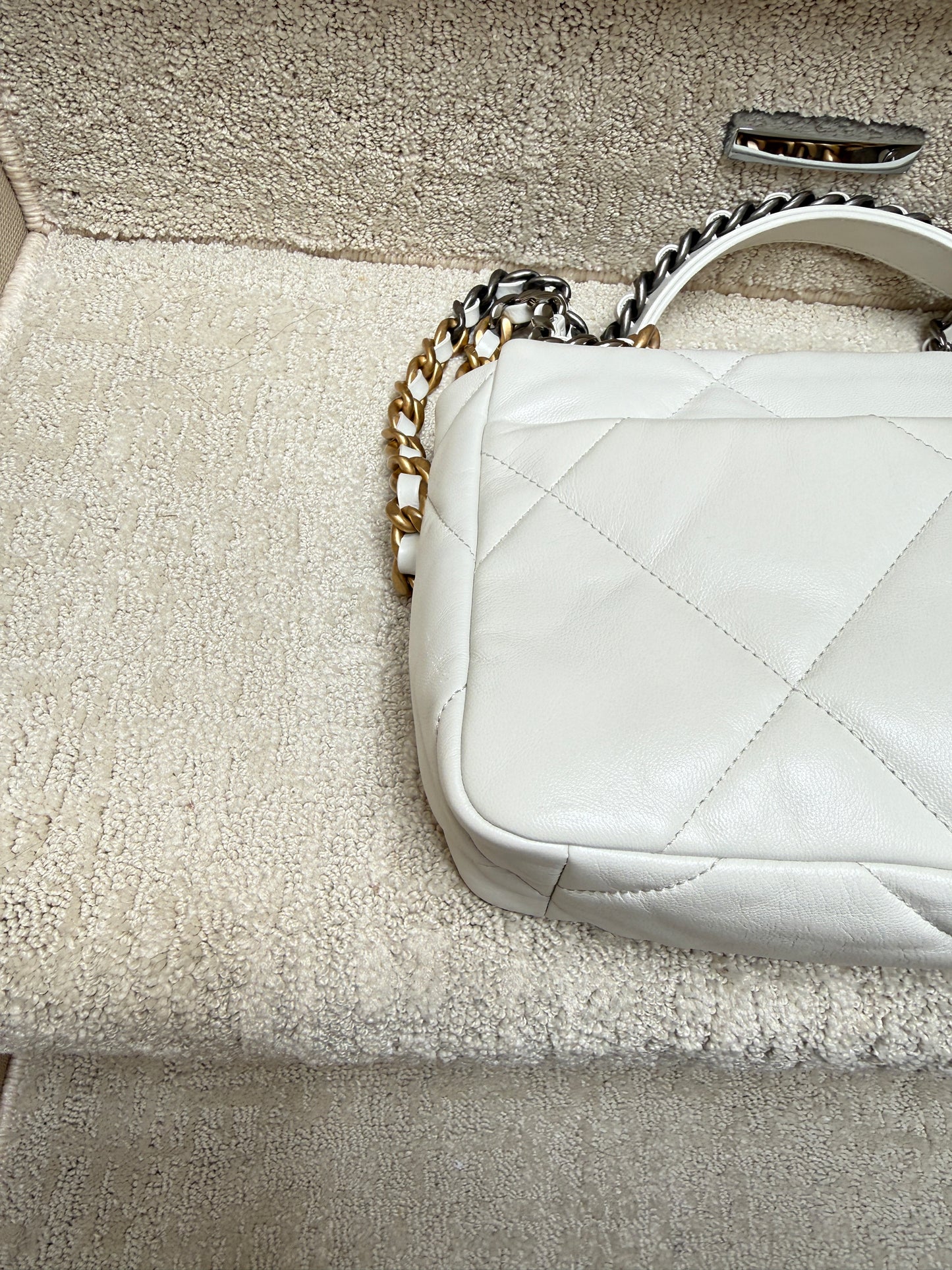 rear left corner close up of corner on chanel 19 in white leather