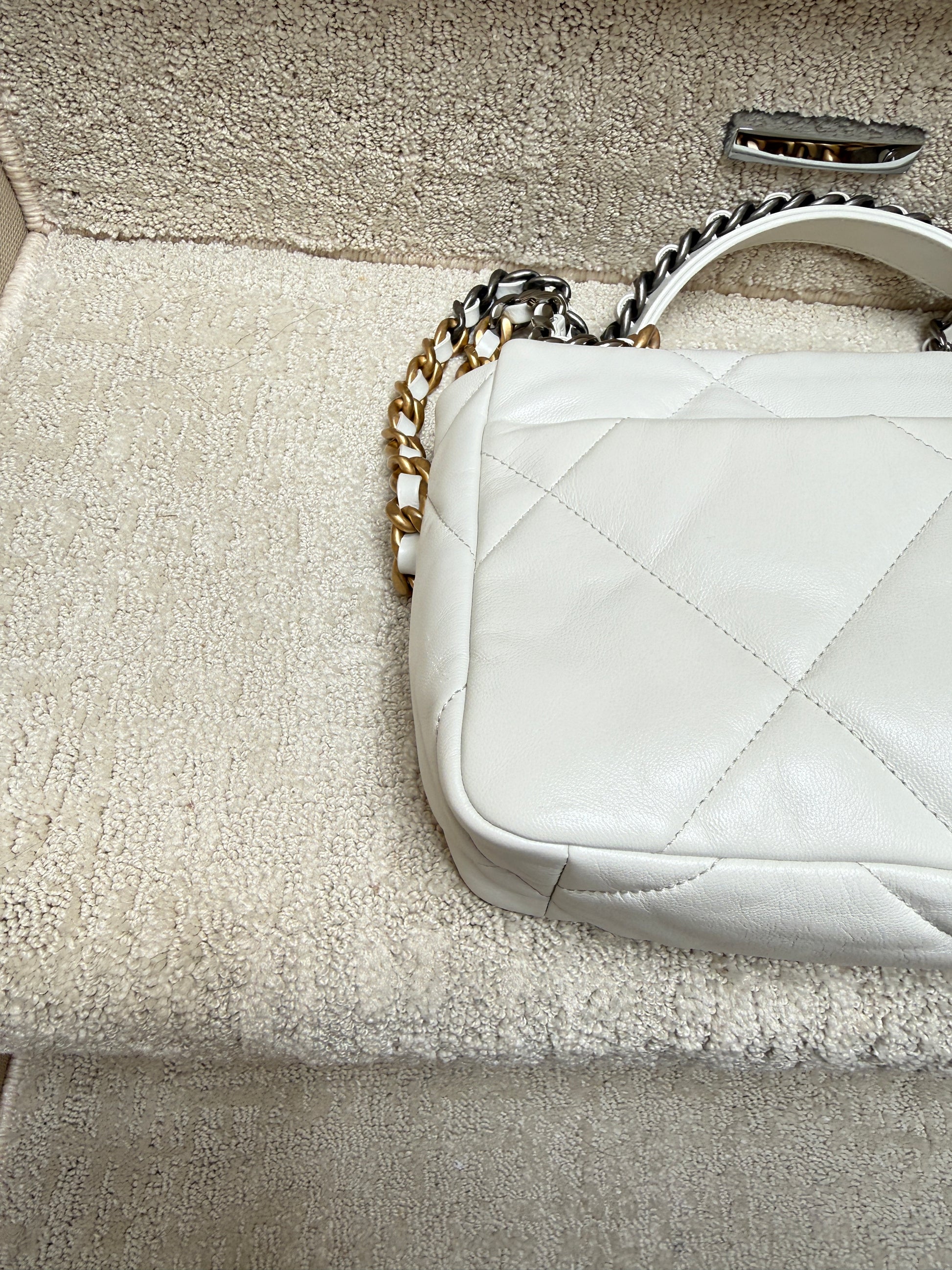 rear left corner close up of corner on chanel 19 in white leather