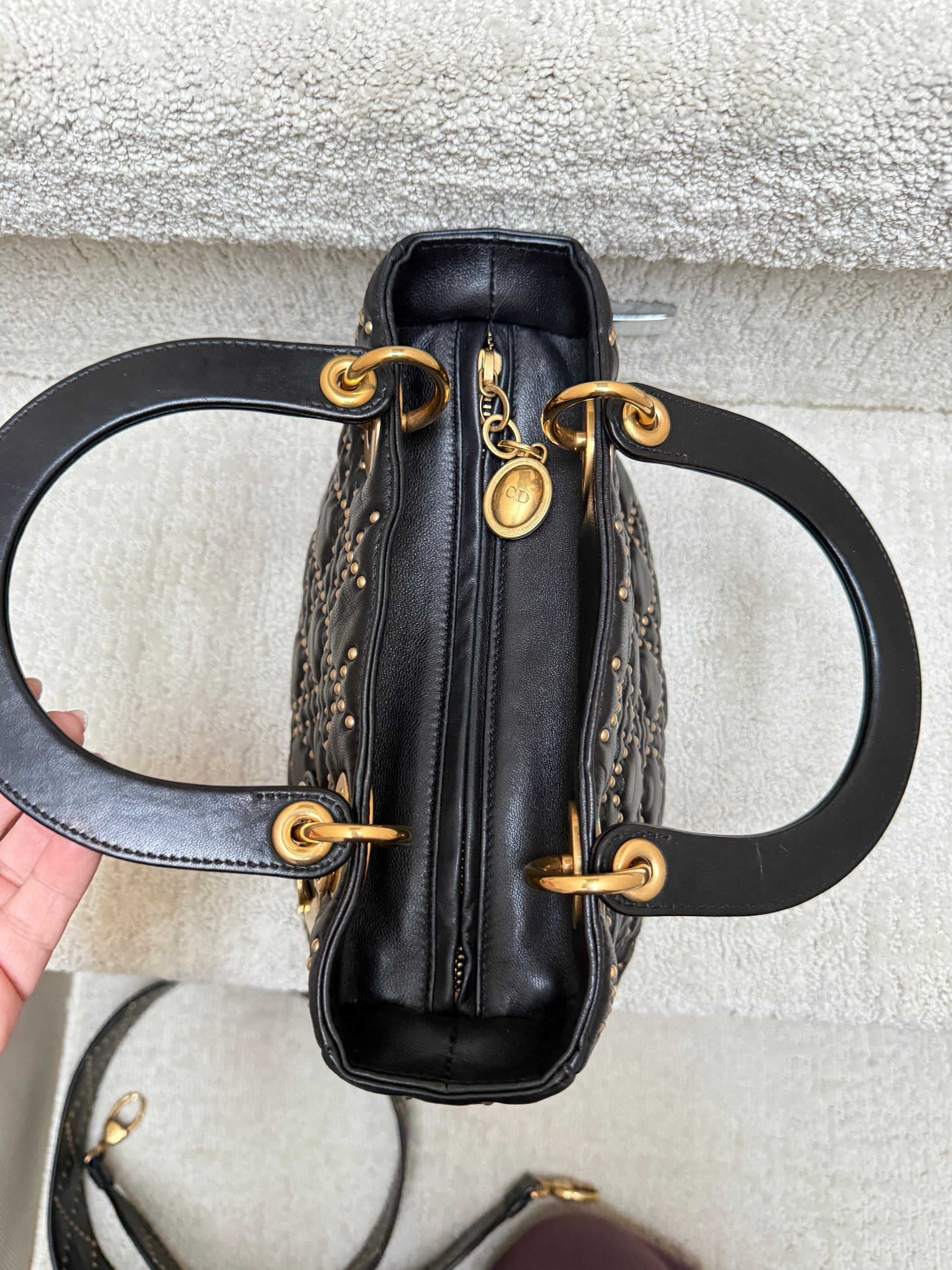 Lady Dior by Christian Dior view of top of handbag with zipper pull and leather handles
