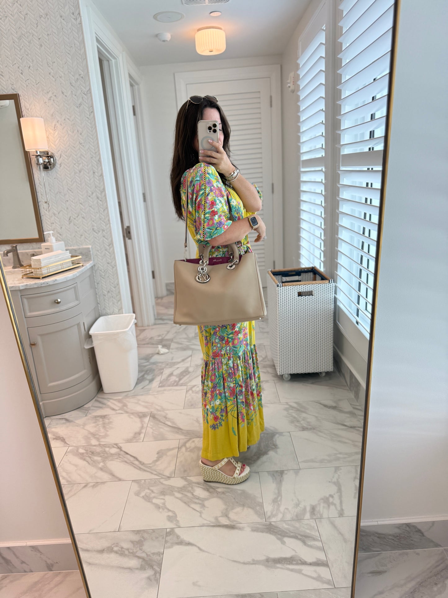 Woman showing dior diorissima tote in beige leather carried on her shoulder for sale