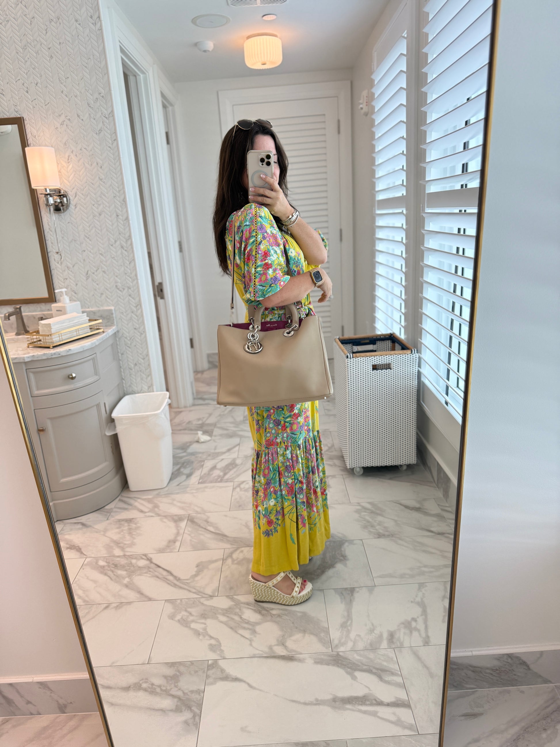 Woman showing dior diorissima tote in beige leather carried on her shoulder for sale