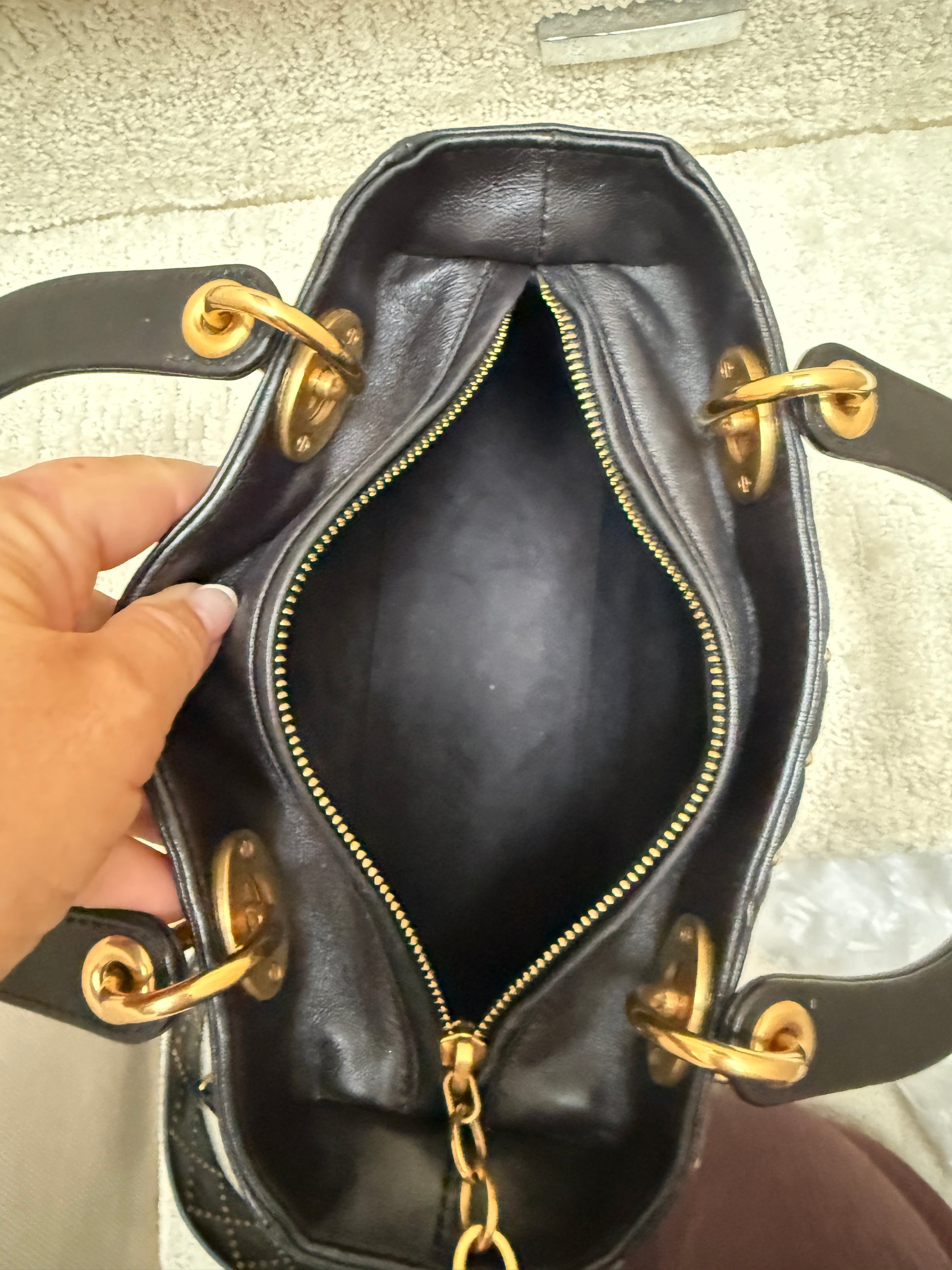 Interior photo of christian dior lady dior medium bag in black and gold