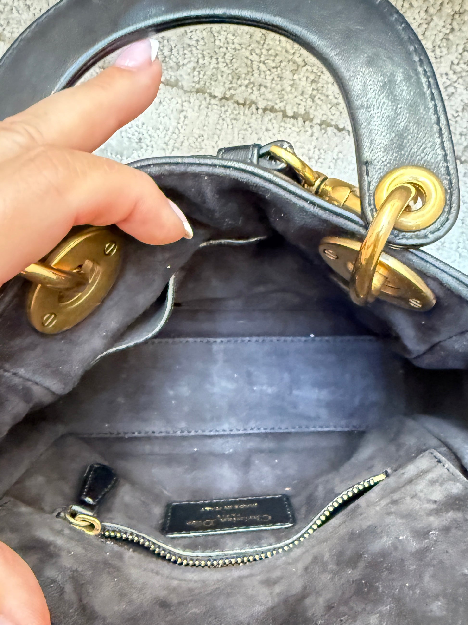 close up of interior of lady dior mini on consignment preloved and very clean with zipper and patch pocket