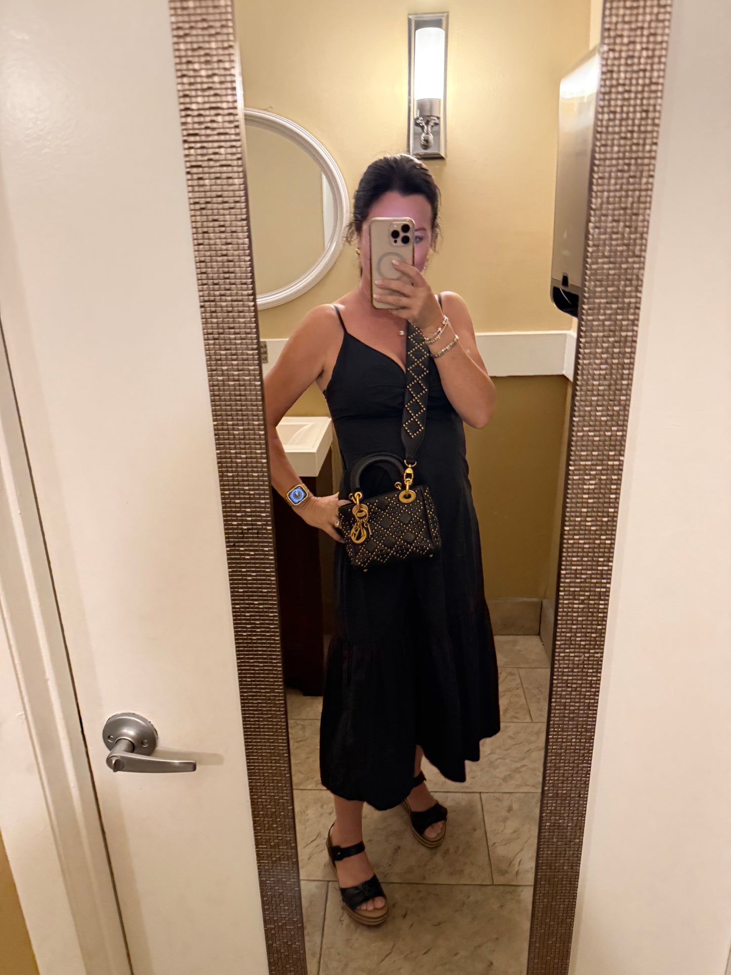 Dior Lady Dior mini with studs shown on woman worn as a crossbody purse for sale.